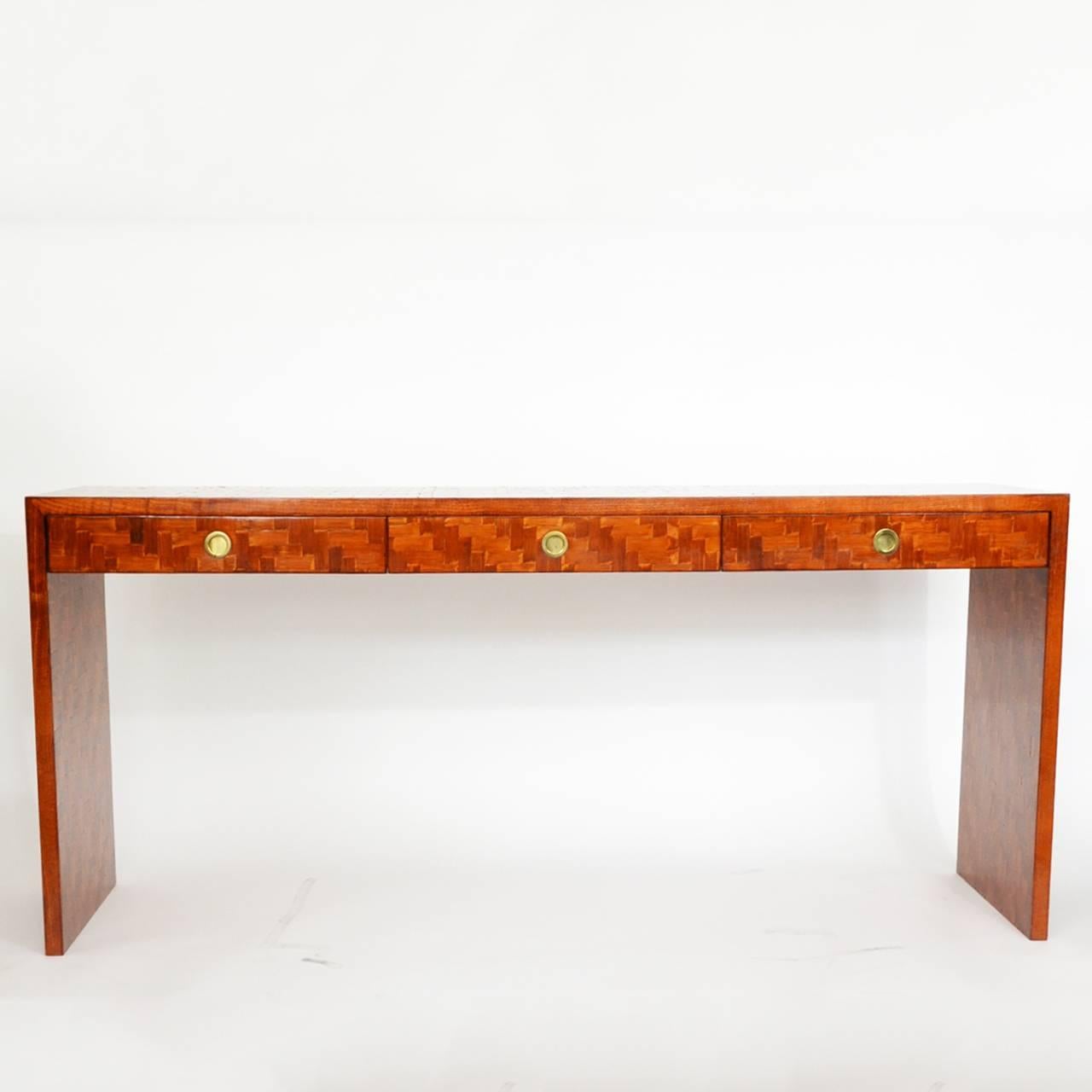 1970s console table by Vivai del Sud.
Made in wood with a motif created from interwoven wood veener.
Three drawers with brass handle.
