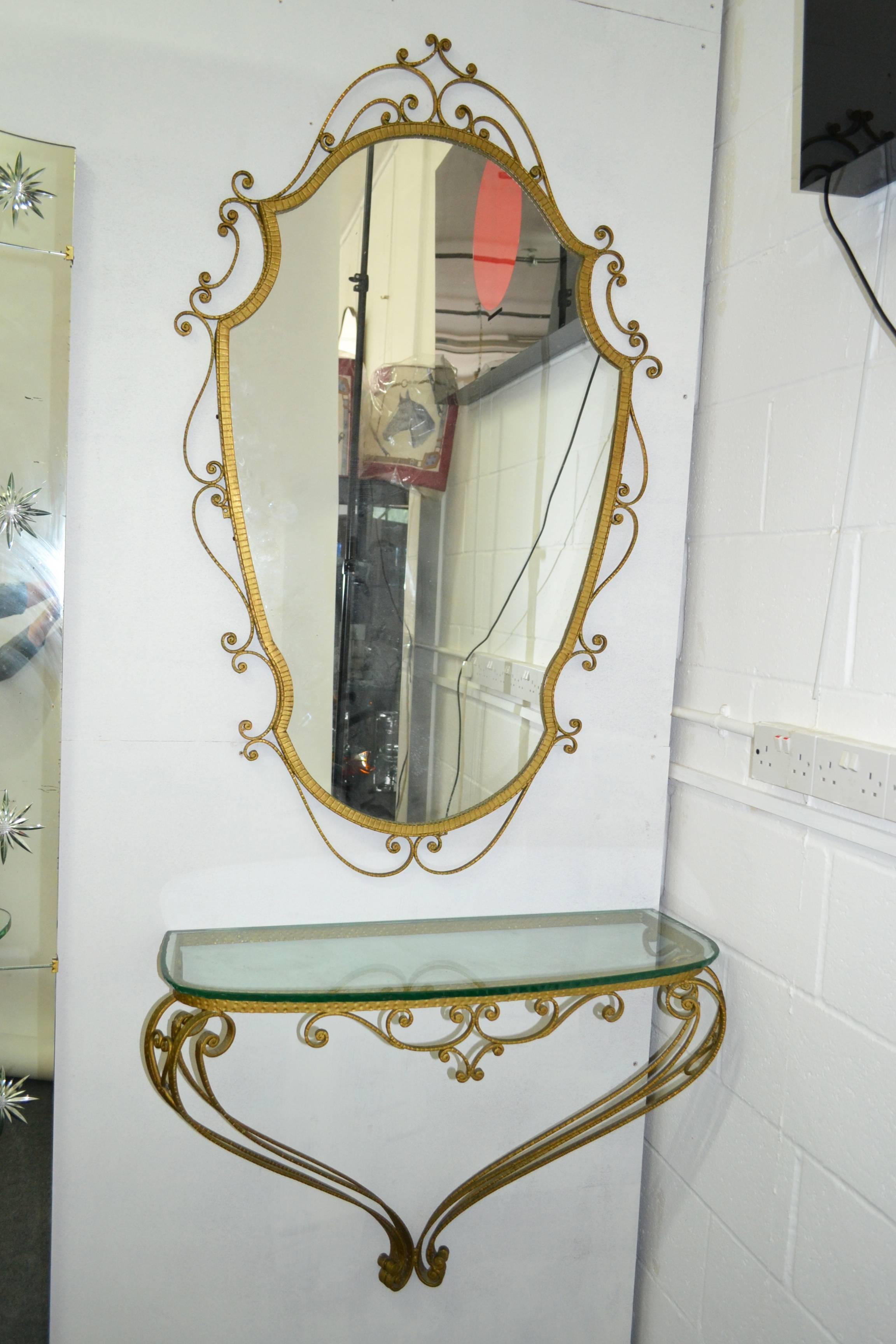 Iron gilt set with mirror and console with thick glass top by Pierluigi Colli-Torino-Italy from the 1950s.
Mirror size: H. 134cm W. 82cm D. 2.5cm.
Console size: H. 62cm W. 88cm D. 33cm.