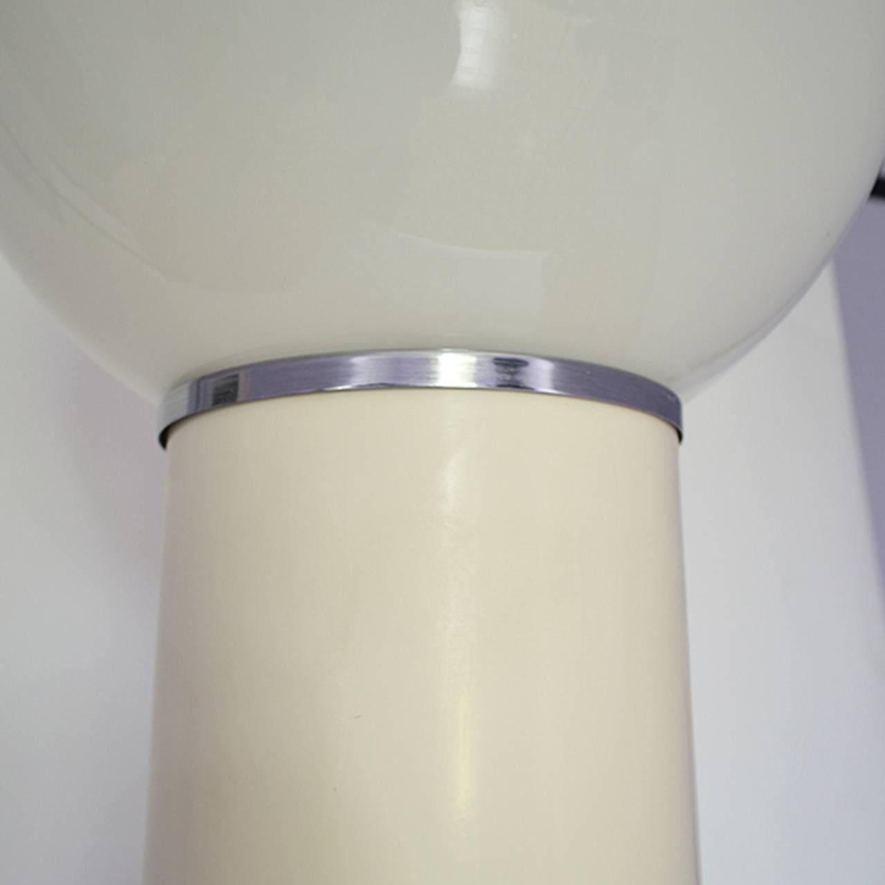 Fiberglass support, chrome and a big white opaline glass ball floor lamp
by Kartell, first year manufacture was 1968.