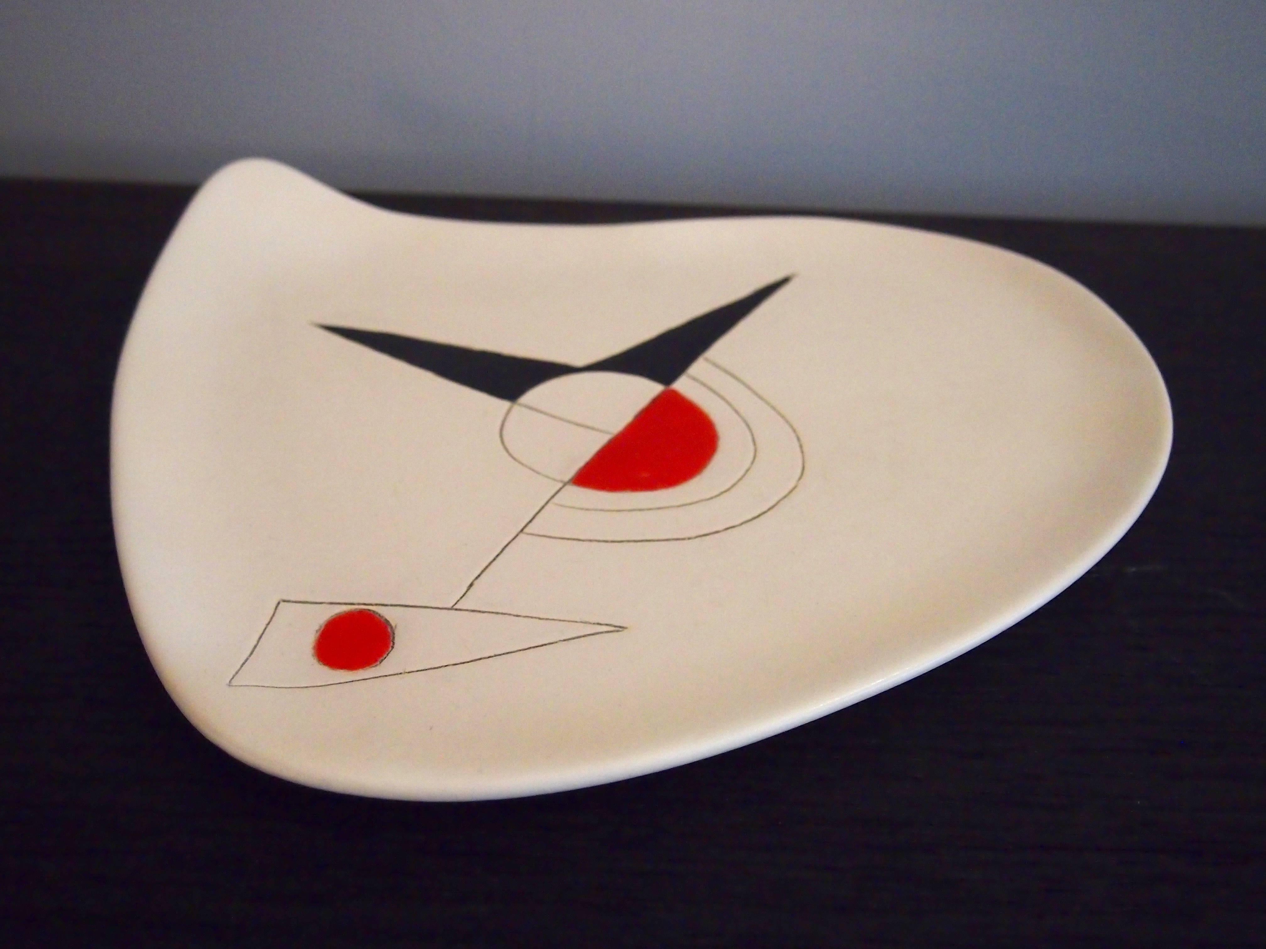 An earthenware shaped dish, glazed in white with an abstract and geometric decoration engraved and over-glazed in red and black.
 
 Unique piece, typical art-work from the french couple of ceramicists. 
 The piece is signed back: 