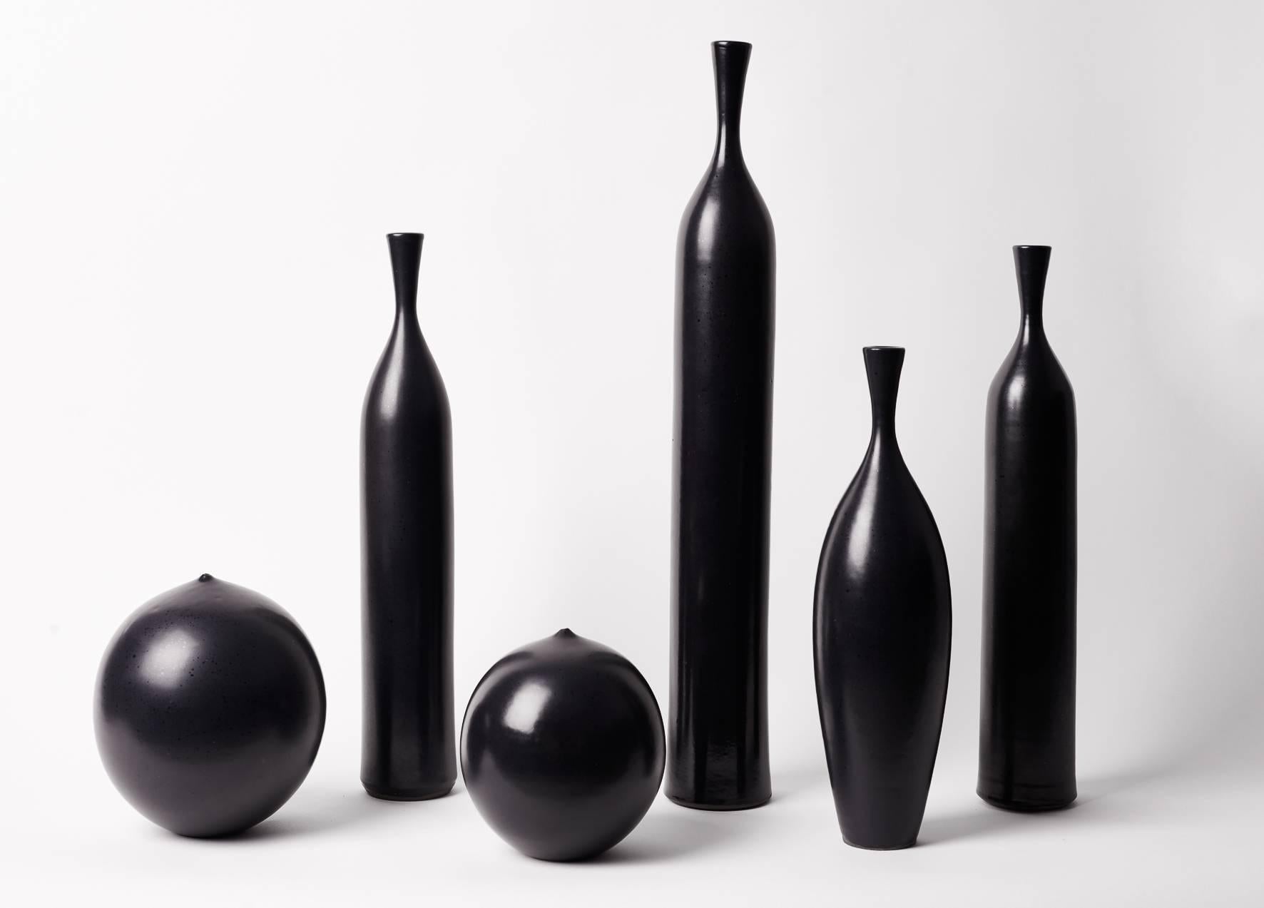 Set of six pieces: Four bottles and two ball vases, black enameled earthenware signed with Jacques Bro stamp.

Heights: 52/40/39/32/19/16 cm.

Between 1950 and 1970, Jacques Bro used to work at Atelier Madoura in Vallauris, France, where he
