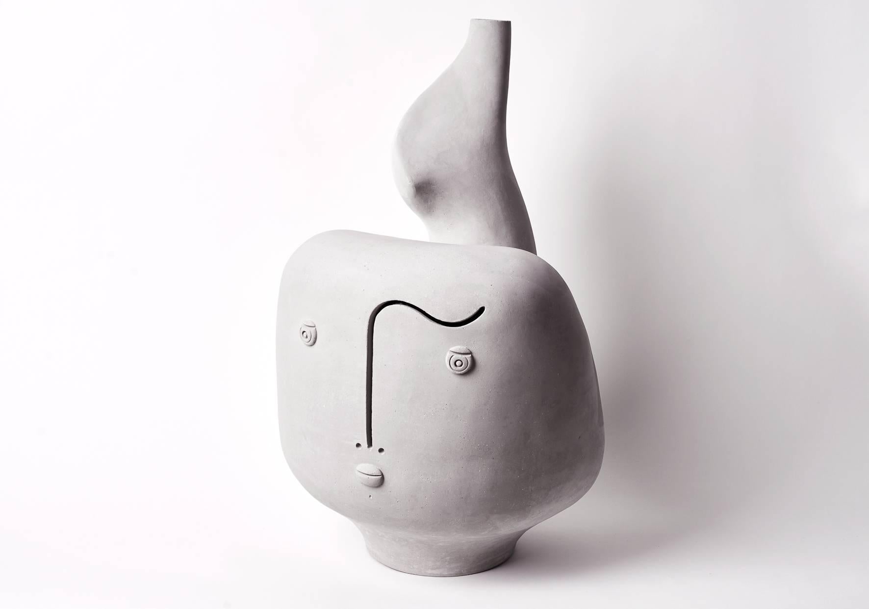 A sculptural and biomorphic shaped lamp-base, natural warm grey stoneware, stylized form, decorated on front with a stylized visage incised.

One of a kind handmade piece, signed by the French ceramicists: Daniel and Loïc, the Dalo.

The height