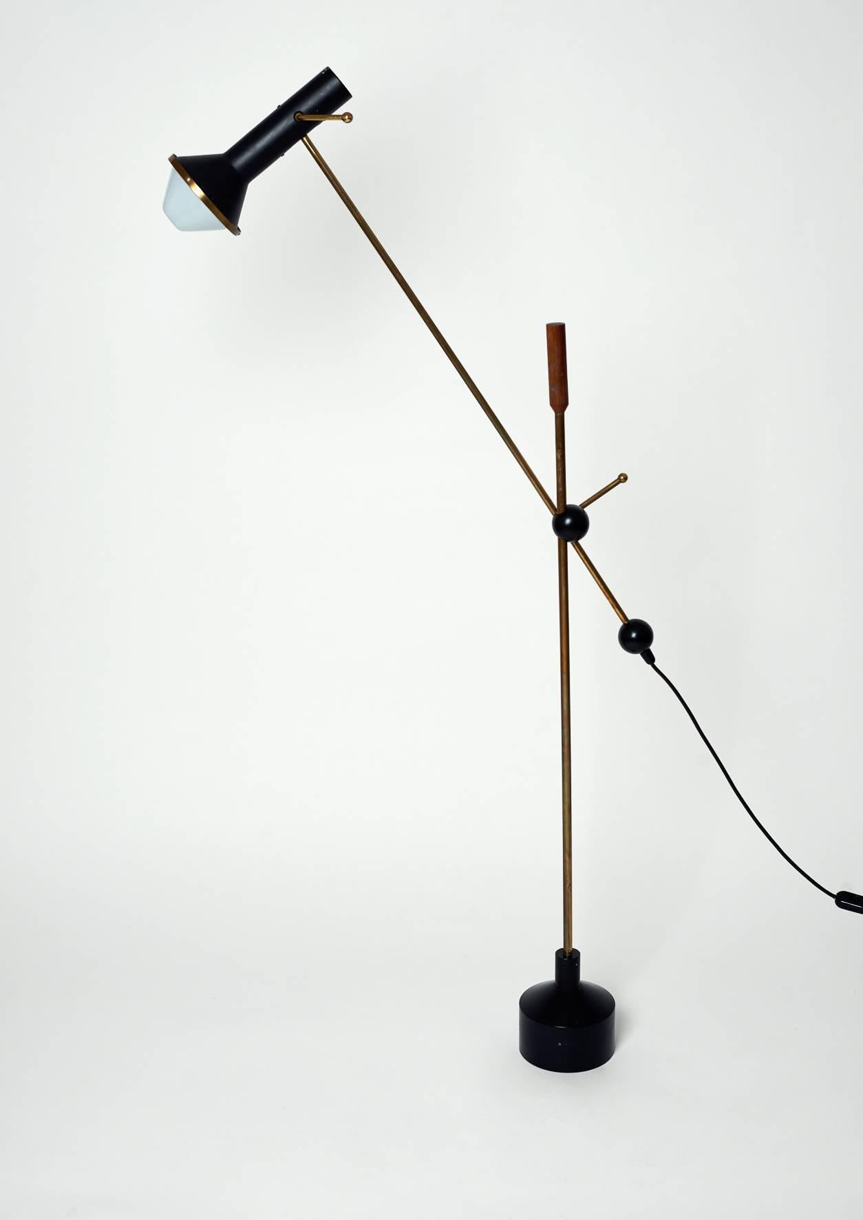 Tapio Wirkkala for Idman-OY, Finland, 1960.
A rare K10-47 floor lamp, heavy cast iron base supporting brass upright with teak handle. The ball joint junction to the lamp arm allows articulation in all directions.
The painted metal shade also