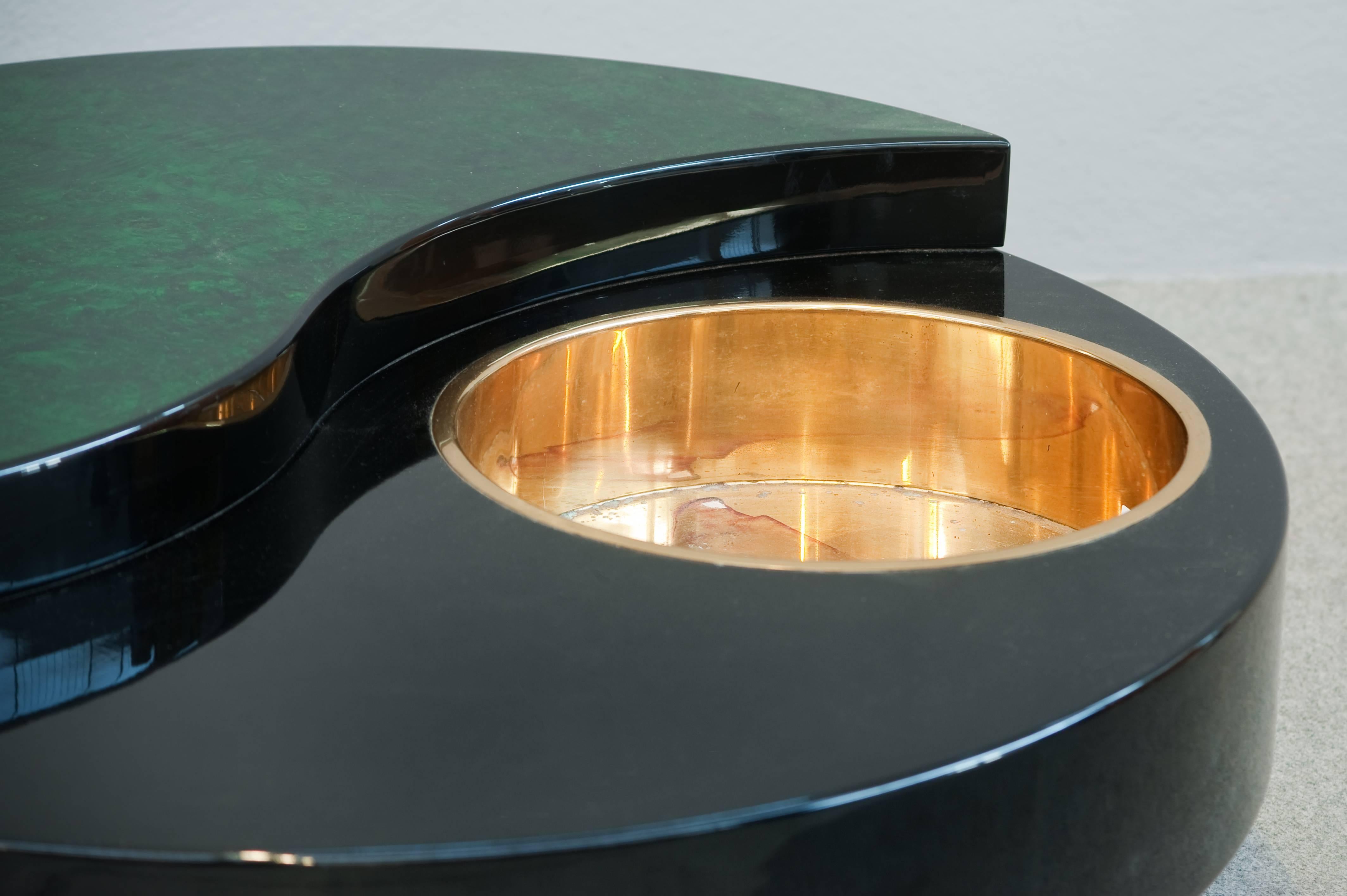 Rotating coffee/cocktail table designed by Willy Rizzo.
Black and green lacquered top on black lacquered wood base. Circular brass bottle tray insert.