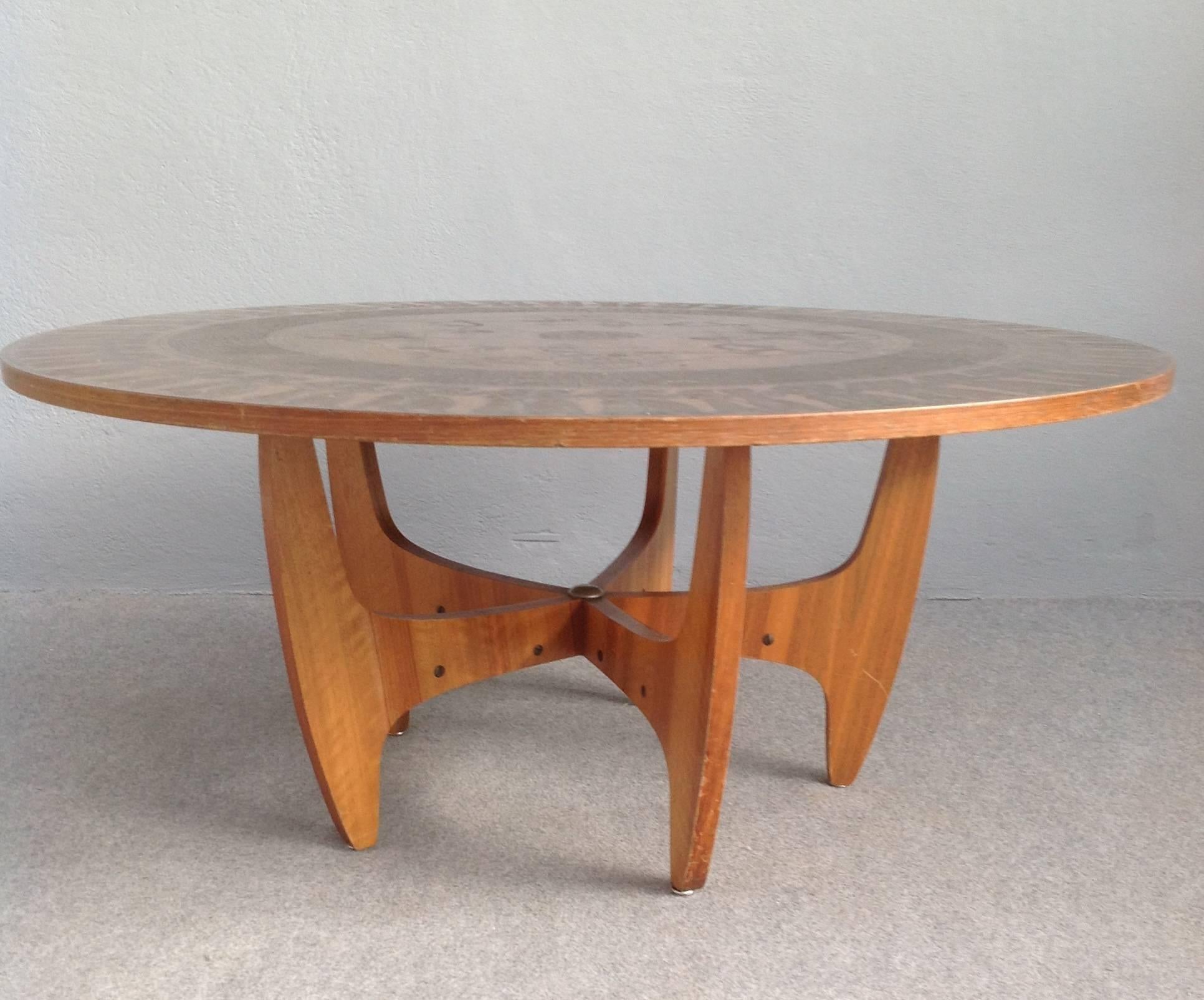 Copper leaf over wood coffee table with relief of Egyptian figures.
Nice sculptural walnut base with brass details.