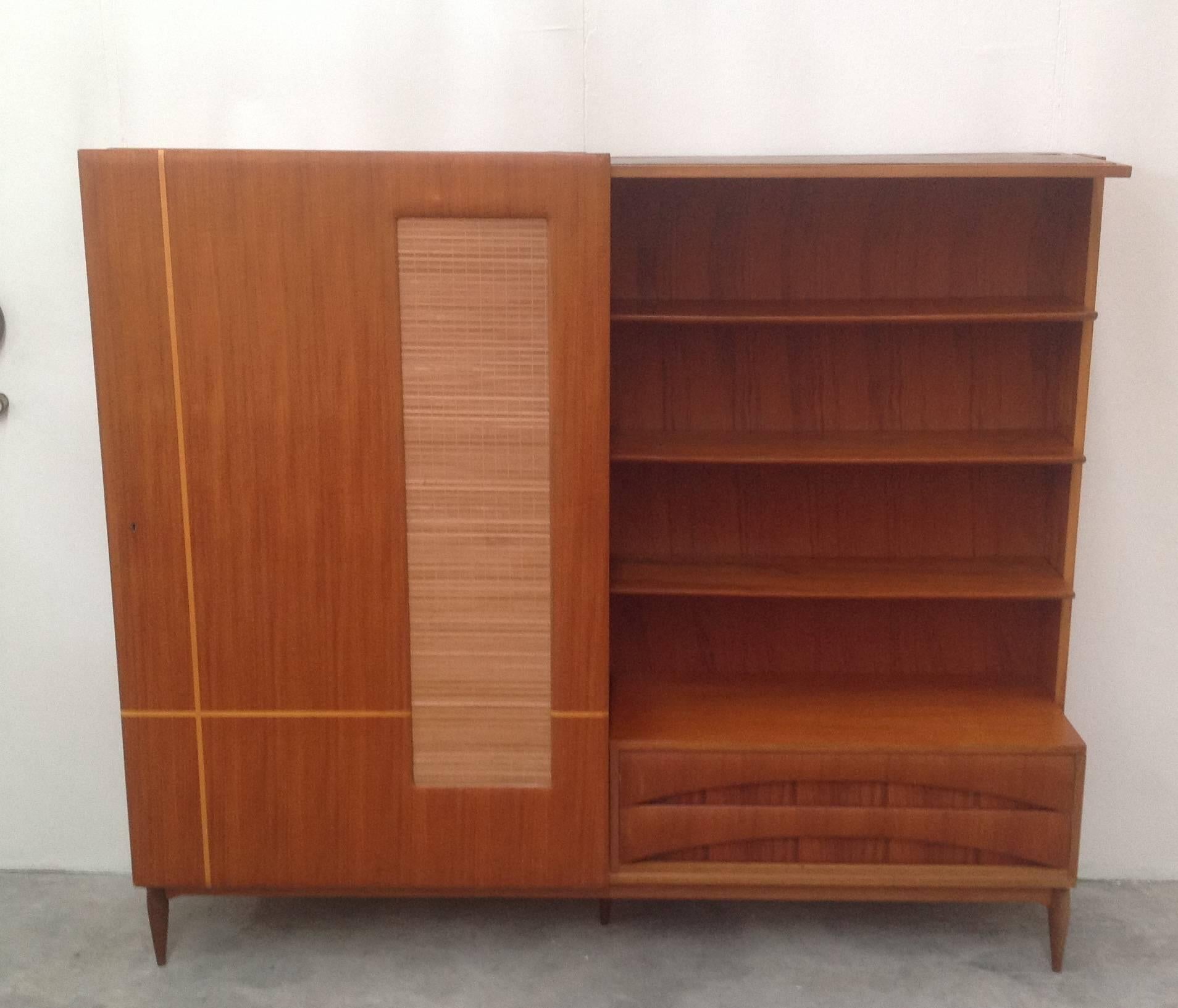 Very nice bookcase with sliding decorated door.