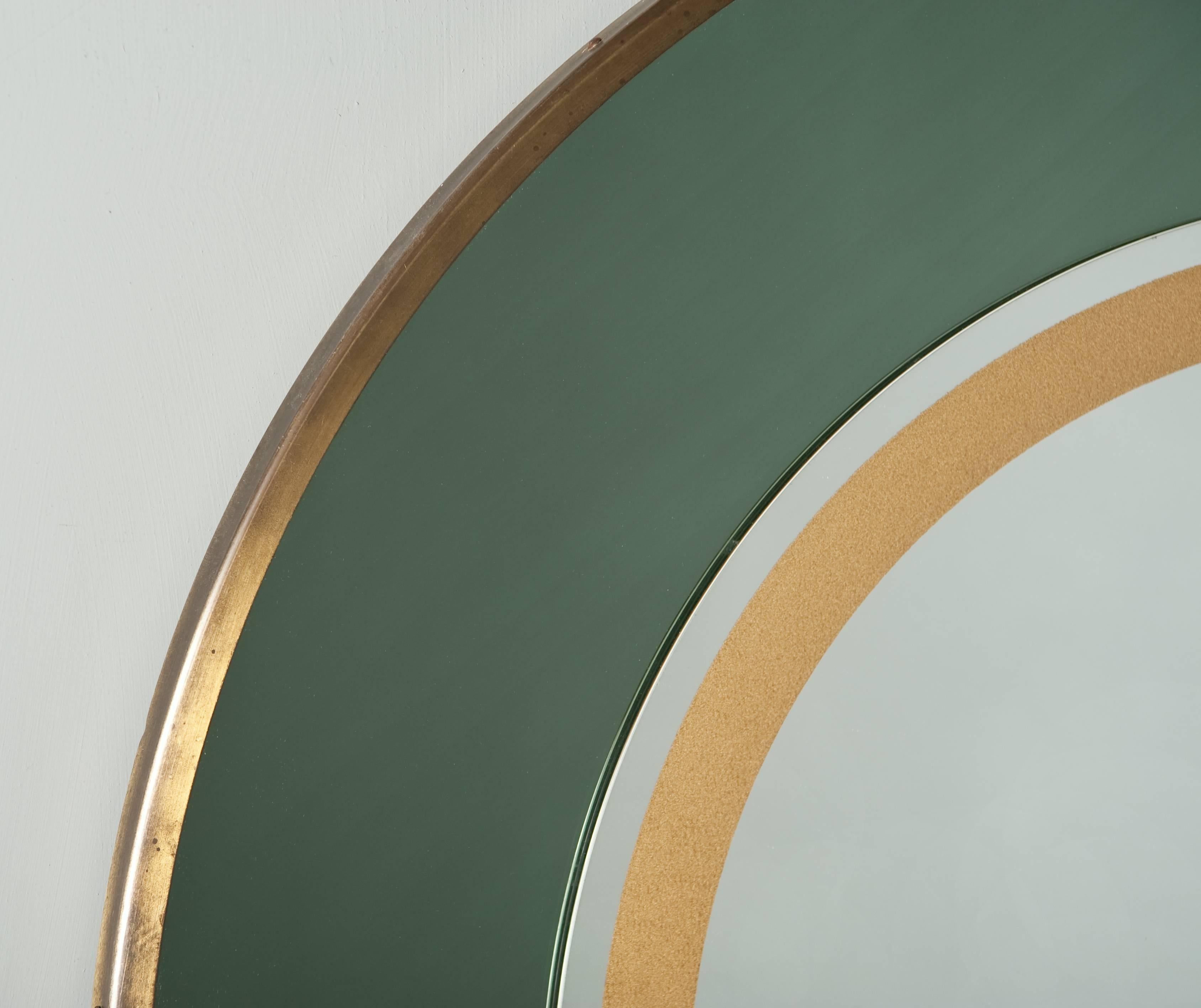 Very nice round green and gold mirror, with brass frame.
