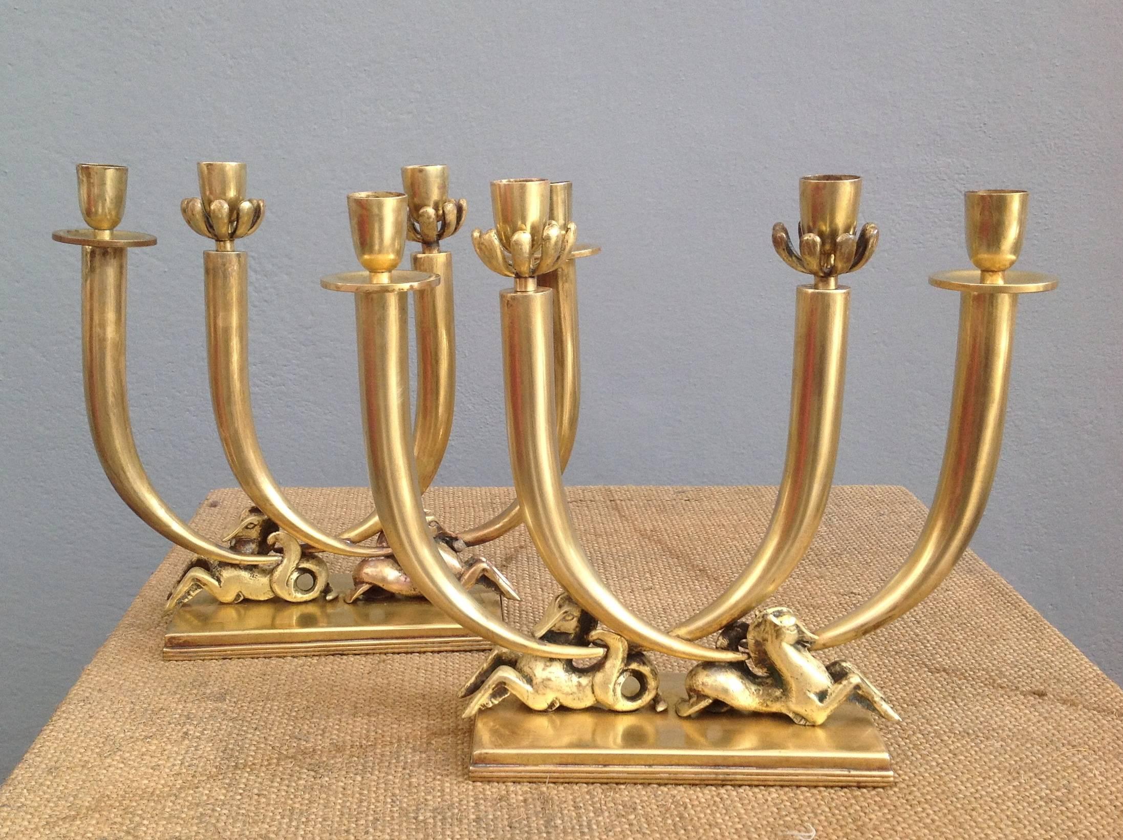 Elegant pair of brass candle holders inspired to Gio Ponti.