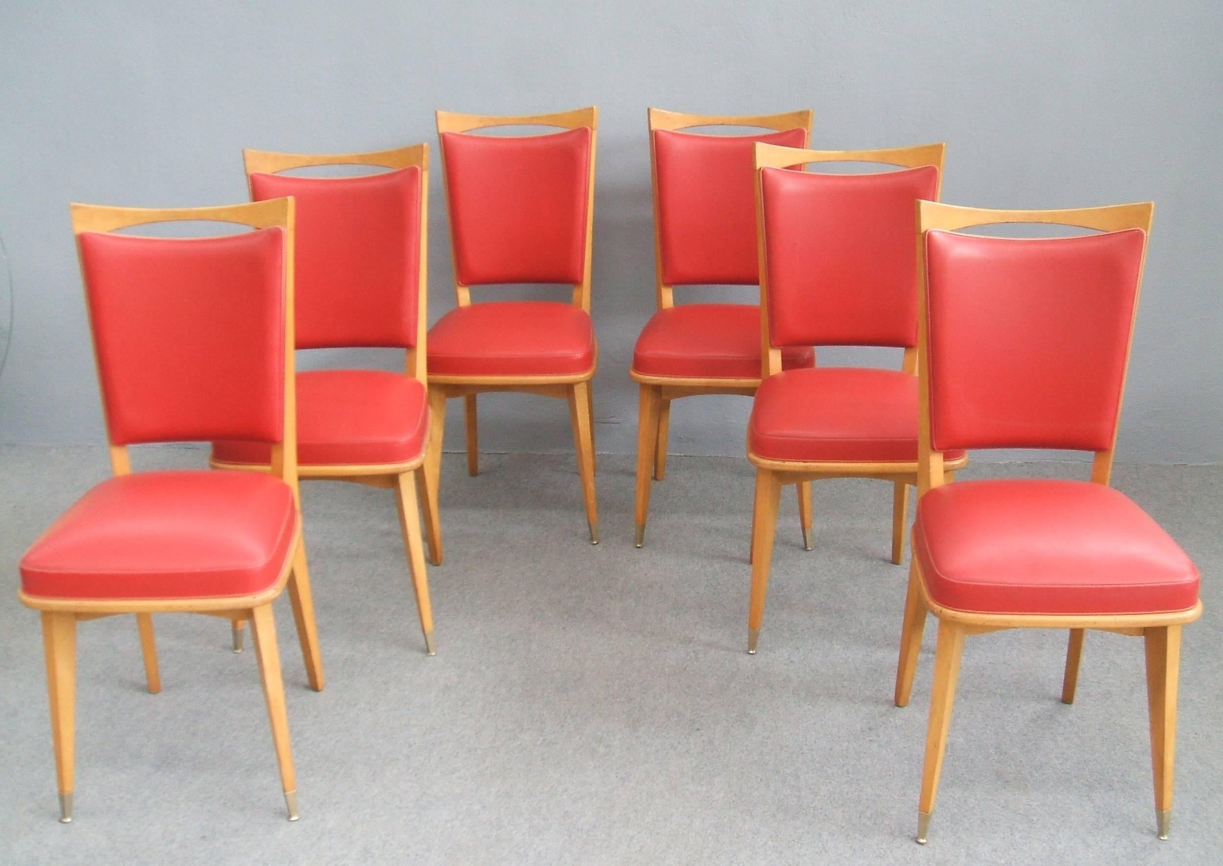 Stunning set of six chairs, red vinyl upholstery, brass sabot.