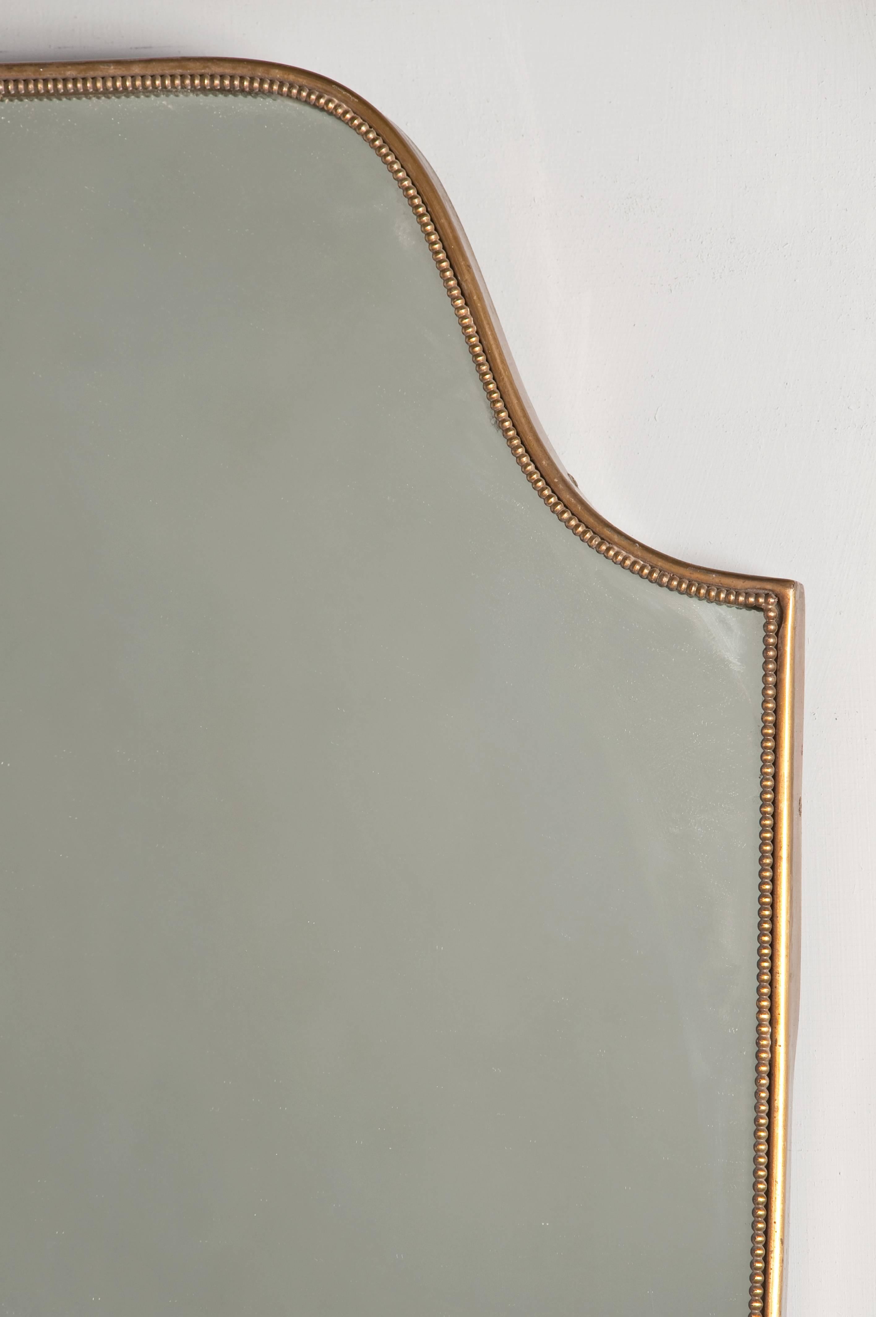 Brass frame, Gio Ponti style wall mirror.