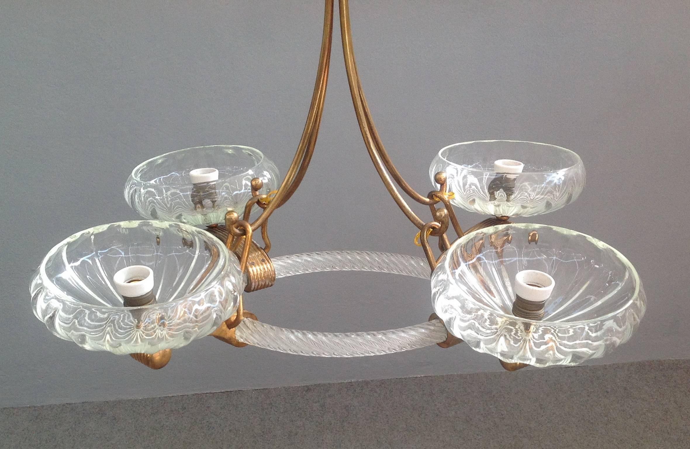 Stunning chandelier attributed to Barovier.
Handblown Murano glass with rare brass details. Four lights.