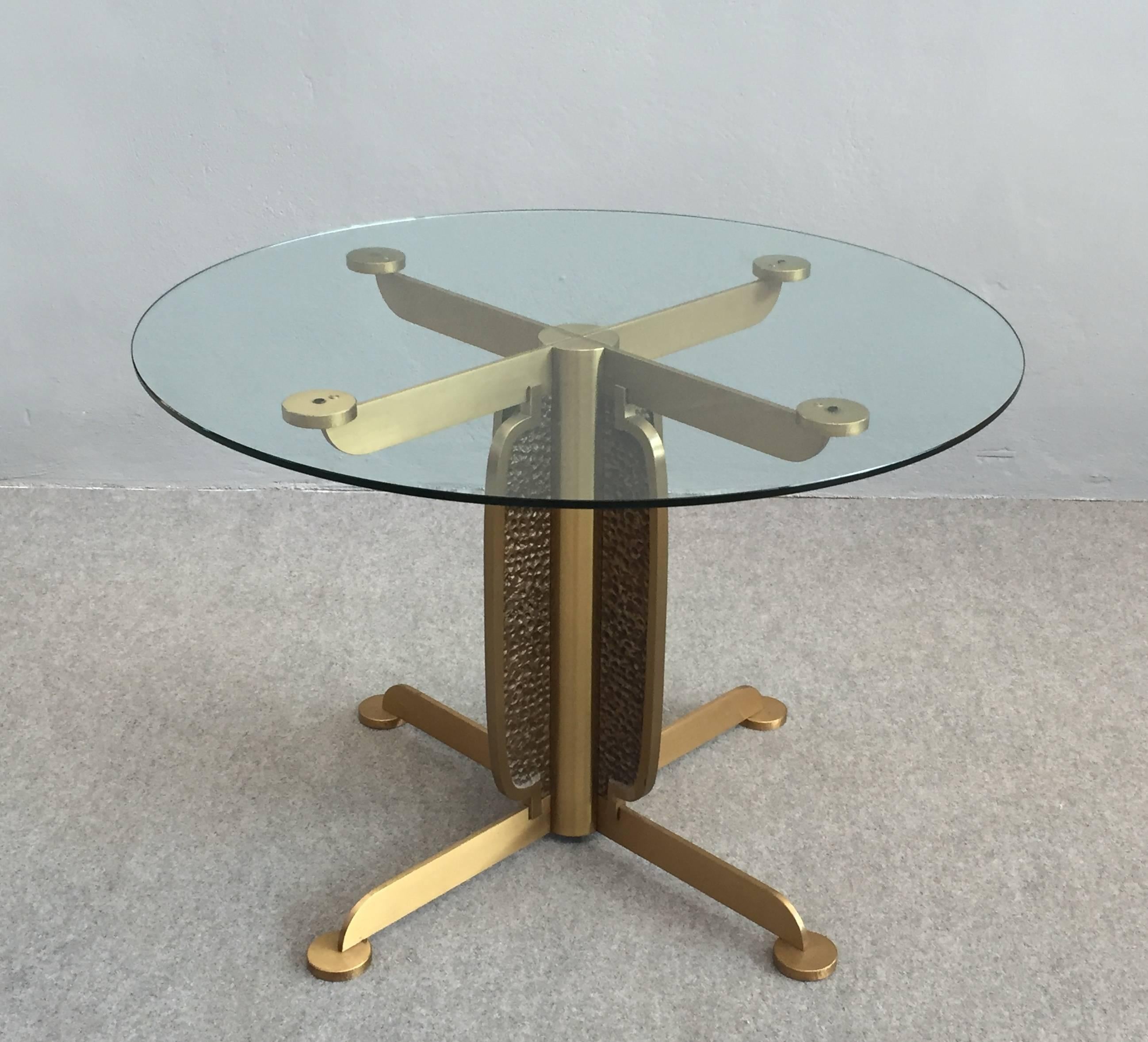 Marvelous sculptural Brutalist brass and glass dining table.