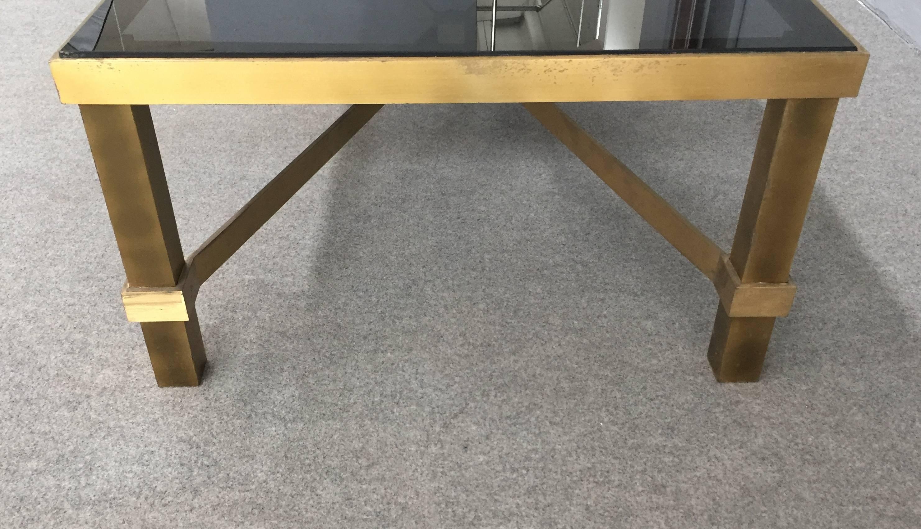 Awesome and sturdy rectangular coffee table, solid brass base and glass top.