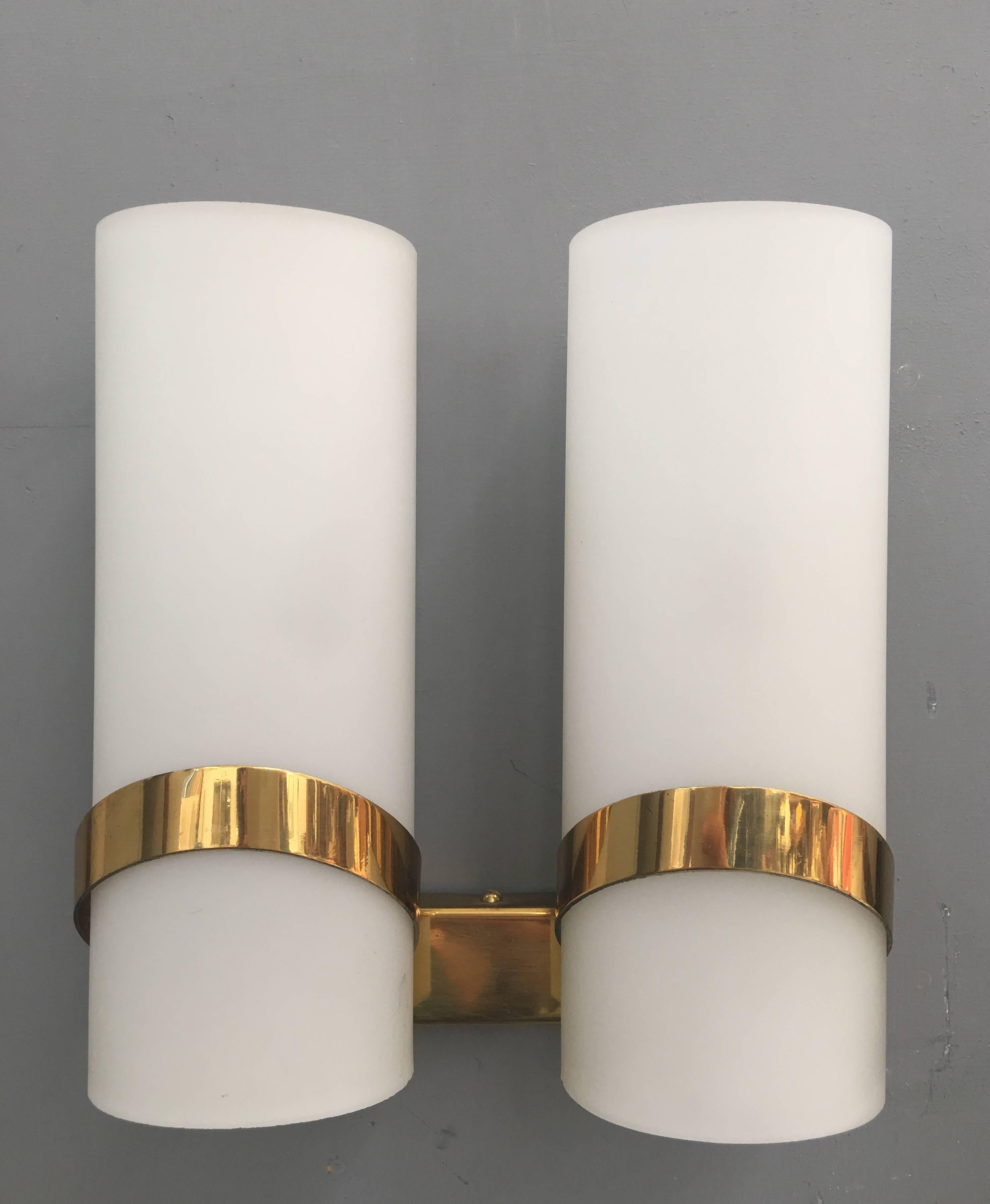 Brass and frosted glass sconces attributed to Stilnovo.
Two single sconces and one double sconce.
Dimension single sconces (cm): D 8, W 8, H 24.