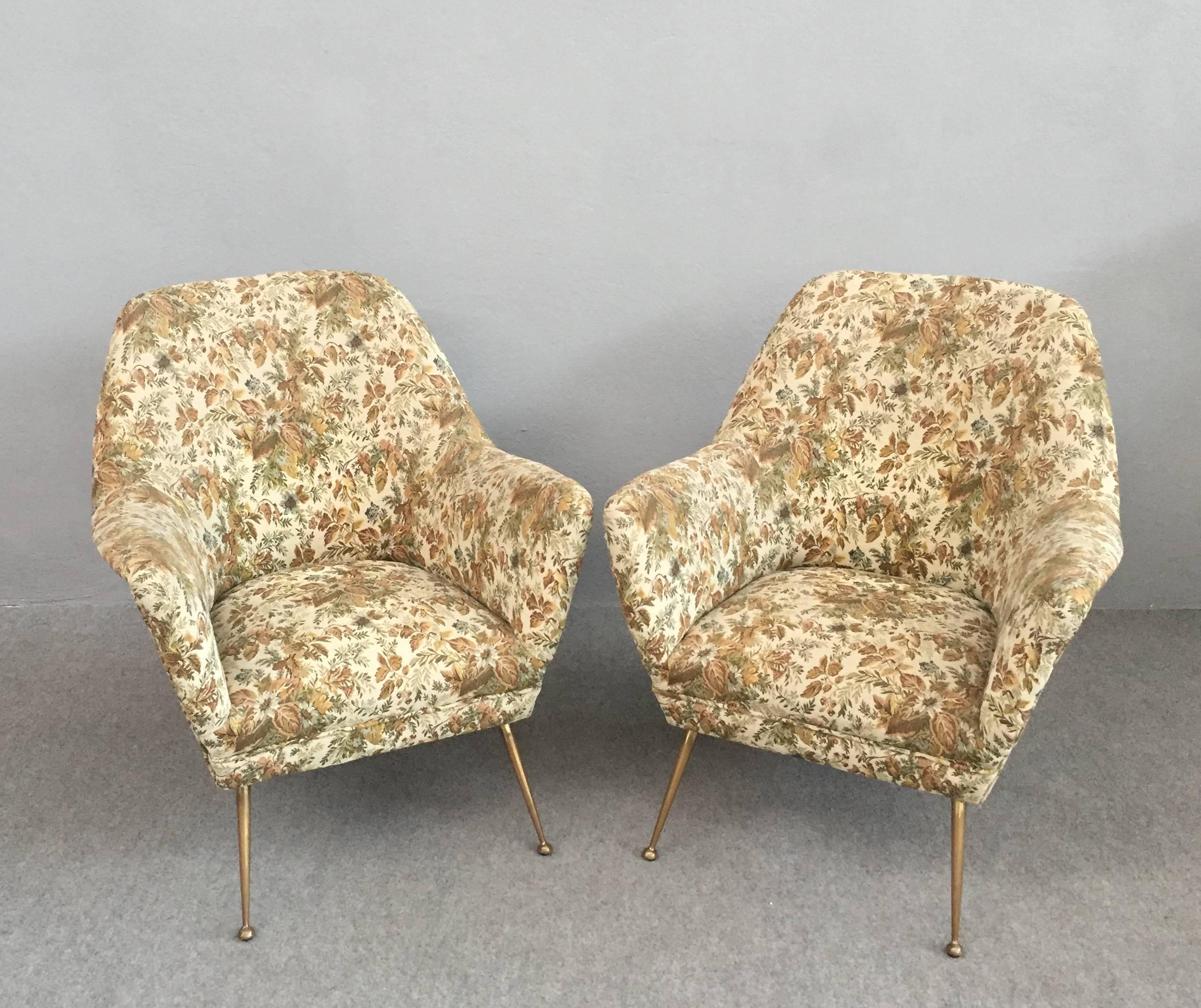 Very elegant shaped armchairs with original fabric.
Solid brass legs.