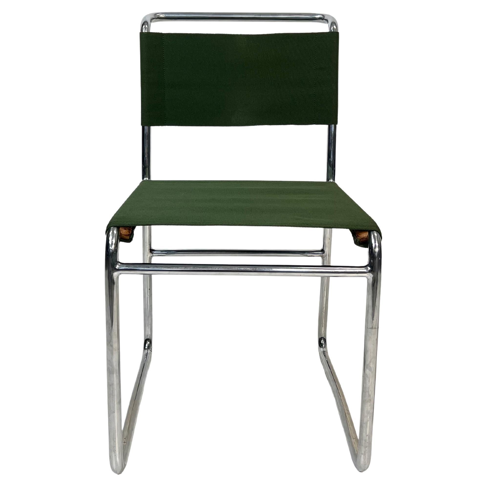A rare and striking example of Czech functionalist design from the 1930s, this tubular steel chair by Hynek Gottwald captures the confident spirit of early modernism. Its clear, minimalist lines—elevated by a carefully restored green iron yarn seat