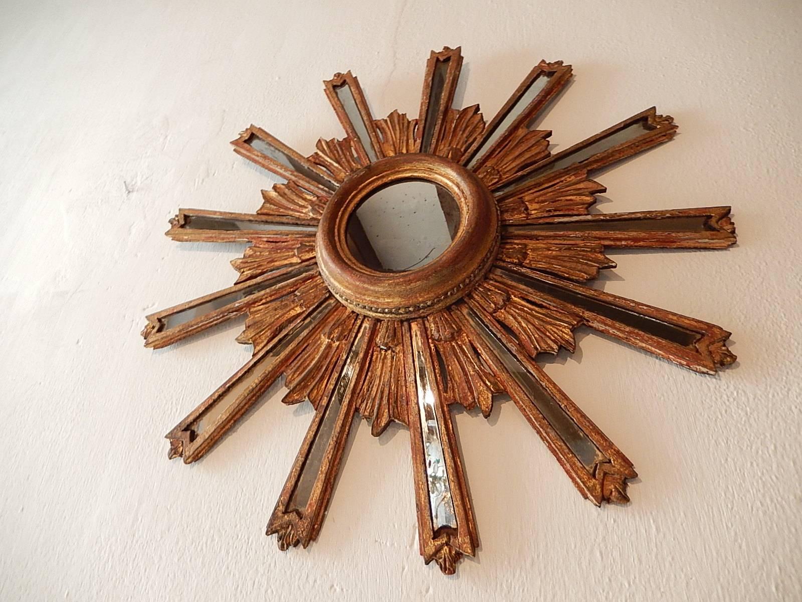 Giltwood with 13 mirrored rays. Centre mirror measures approx. 4.5 inches. One small break in one mirrored ray as shown.