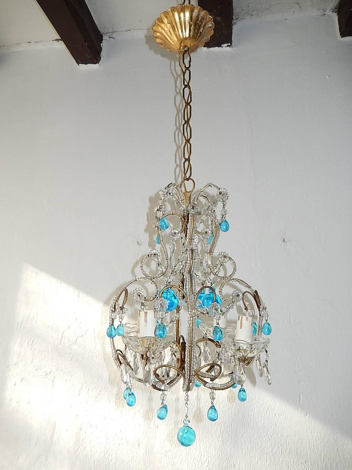 Housing four lights sitting in crystal bobeches, dripping with vintage crystals. Rewired and ready to hang. Double beaded frame with swags of macaroni beads. Adorning both small and large blue Murano drops. Adding another 12 inches of original chain