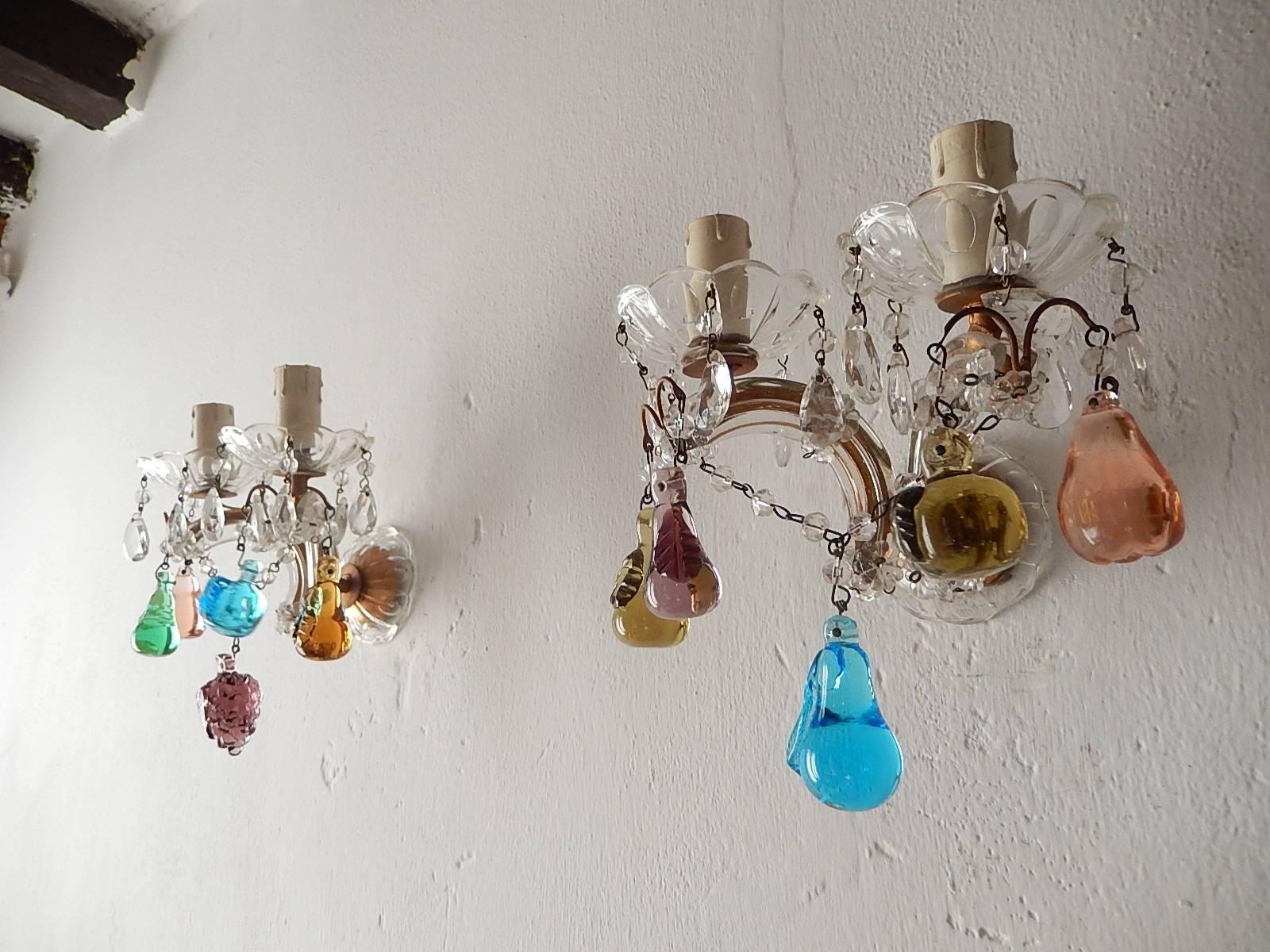 Housing 2 lights each, sitting in crystal bobeches, dripping with vintage crystals.  Gilt metal covered with Murano glass.  Adorning 5 Murano fruits on each.  Back plate is also a crystal bobeche.  Re-wired and ready to hang.  Free priority shipping
