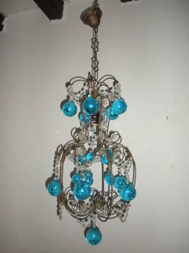 Housing 1 light, already rewired and ready to hang!  The light is  sitting in a crystal bobeche, dripping with vintage crystal prisms. Swags of macaroni beads and florets throughout.  Adorning huge Murano balls and matching small ones. Add 10 inches