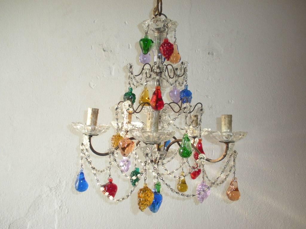 Housing five lights, sitting in crystal bobeches. Adorning swags of macaroni beads and colourful Murano fruit throughout. Adding another 20 inches of original chain and canopy. Re-wired and ready to hang. Free priority shipping from Italy.