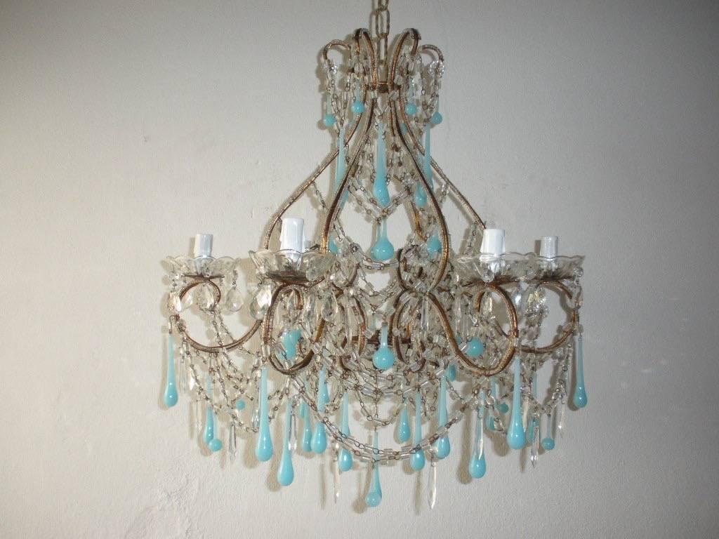 Housing six lights, sitting in crystal bobeches dripping with vintage crystals.  Double beaded throughout with swags of macaroni beads and small crystal prisms. Also adorning rare three sizes of blue Murano opaline drops. Florets throughout.  Not