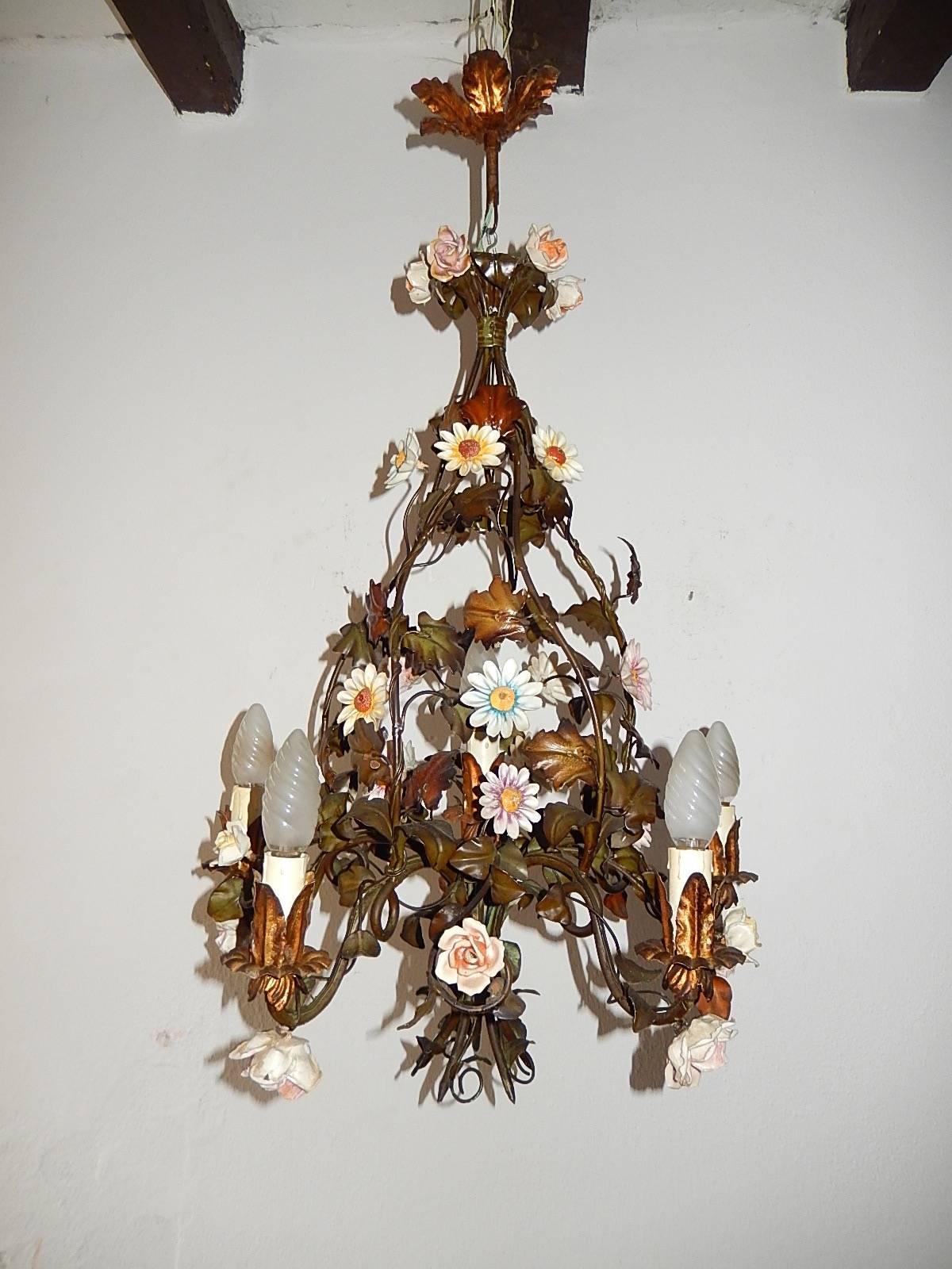 Housing six lights, five encircling and one in center. Tole leaves with porcelain flowers in all shapes, sizes and colors. Original canopy intact. Re-wired and ready to hang. Free priority shipping from Italy.