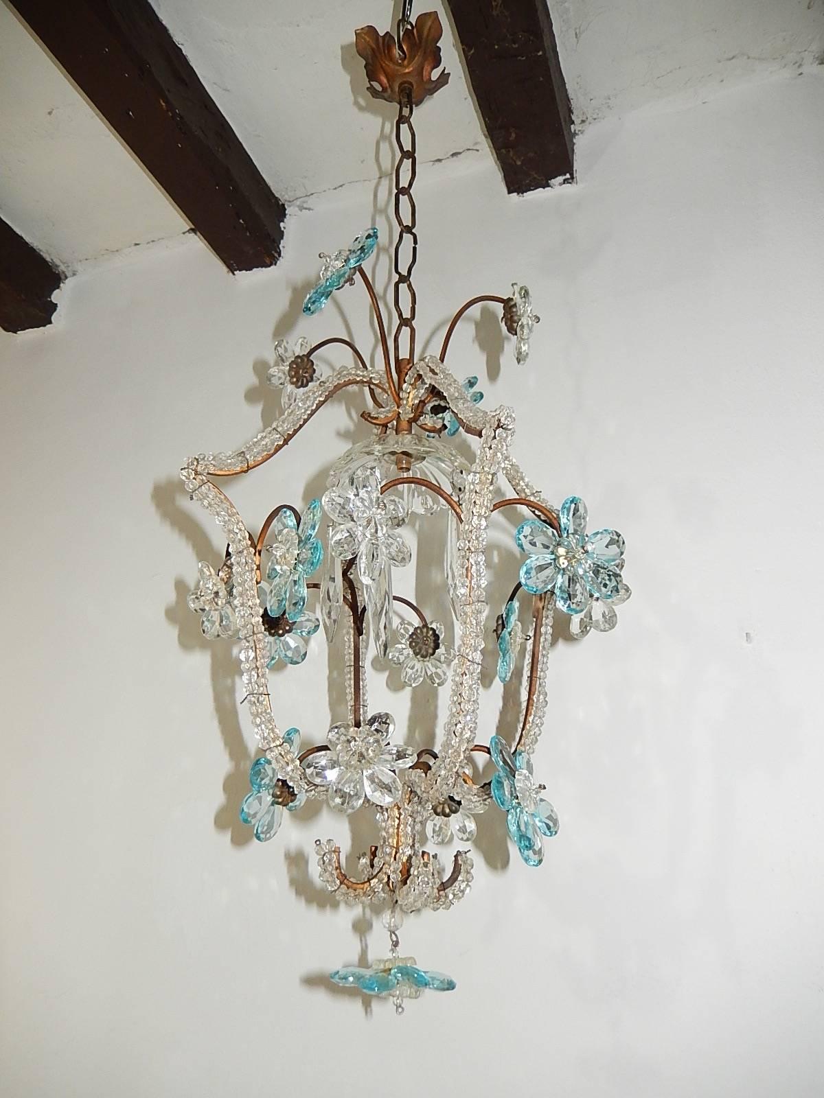 Housing one light, under a crystal bobeche dripping with big crystal spears. Adorning 17 crystal prisms flowers in aqua and clear. Body is triple beaded. Adding another 20 inches of original chain and canopy. Re-wired and ready to hang. Free