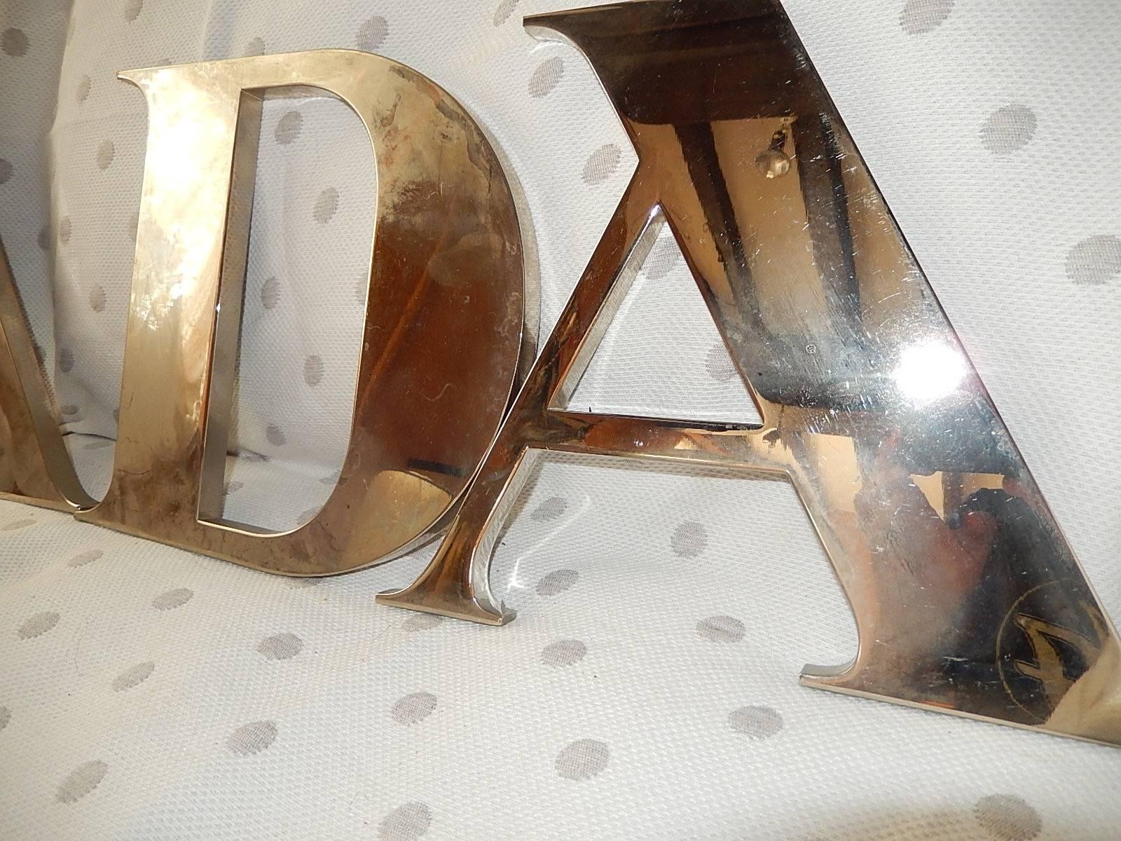 Fabulous original vintage Prada aluminum letters. These came from a store Milan that changed these out since they show wear and tear. Some scuffing and some spots that are not as shiny as the rest and some peeling. Small first two letters stand 8