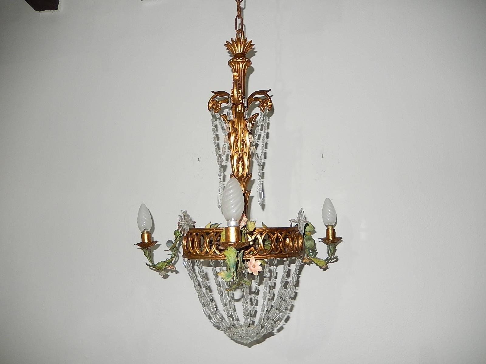 Housing four lights, three on sides, one on bottom. Rewired and ready to hang. Hand-carved giltwood with intricate details. Tole arms (detachable) floral bulb holder arms, wood center. All original paint. Adorning crystal swags encircling this