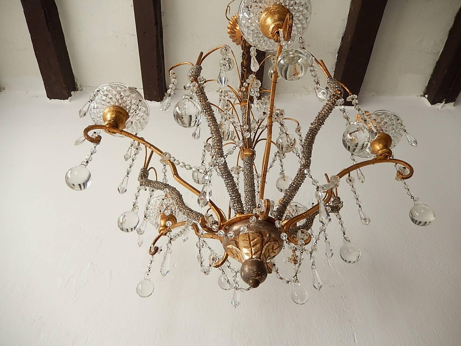 Housing five lights.  Will be rewired with certified US UL sockets for the USA and ready to hang. Crystal bobeches on giltwood posts. Micro beaded center and arms. Swags of crystal balls. Crystal prisms and short Murano bulbous drops. Big polychrome