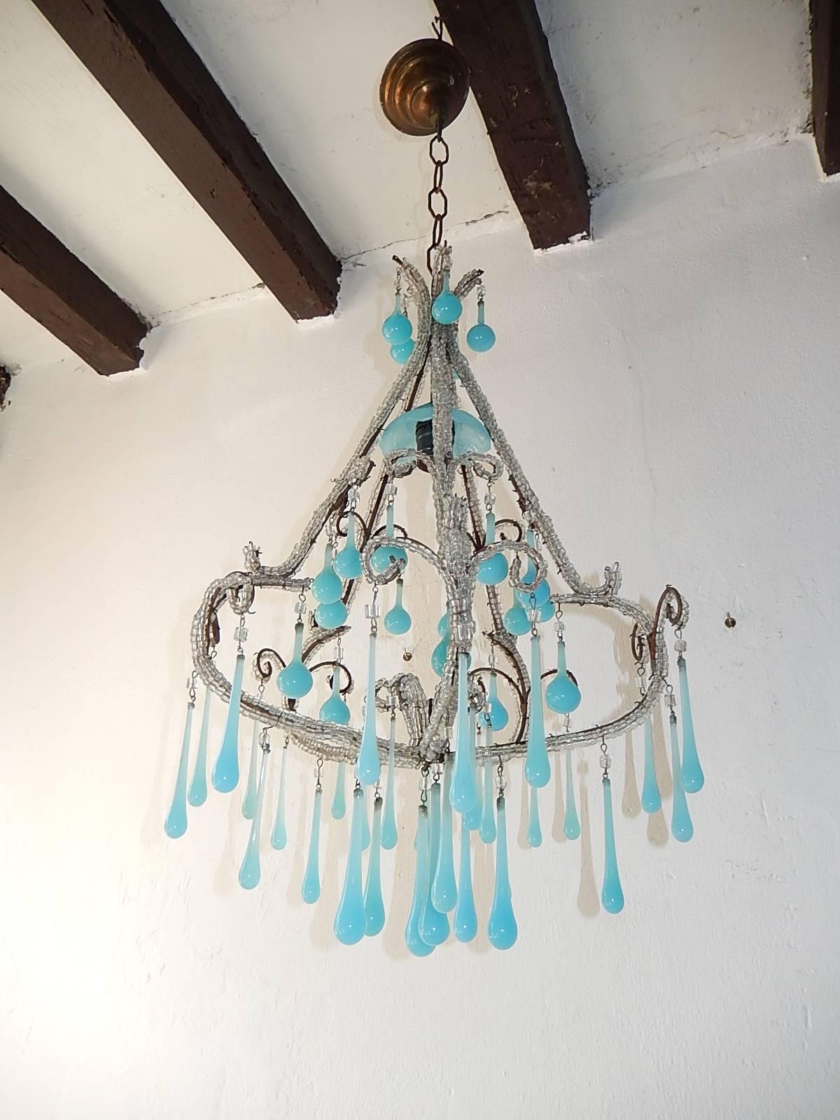 Housing one light, sitting under a blue opaline bobeche. Rewired and ready to hang. Gold gilt metal. Macaroni crystal triple beading. Adorning blue opaline drops in different shapes and sizes. Free priority shipping from Italy. Adding another 11