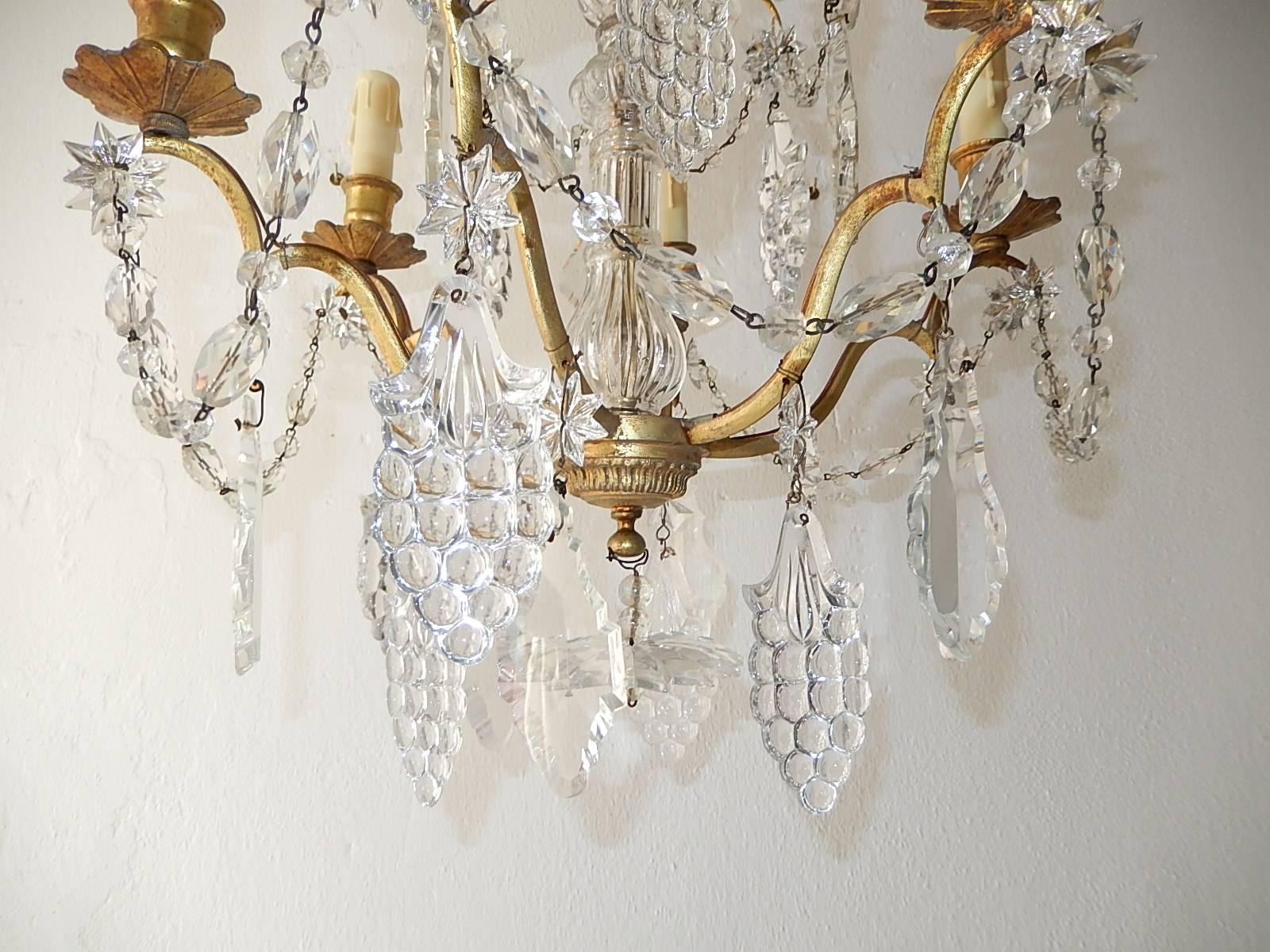 Housing six lights, star prisms throughout with crystal prisms and rare grape cluster prisms. Blown glass centre. Huge star as finial. Re-wired and ready to hang. Adding 6 inches of original chain and canopy. Free priority shipping from Italy.