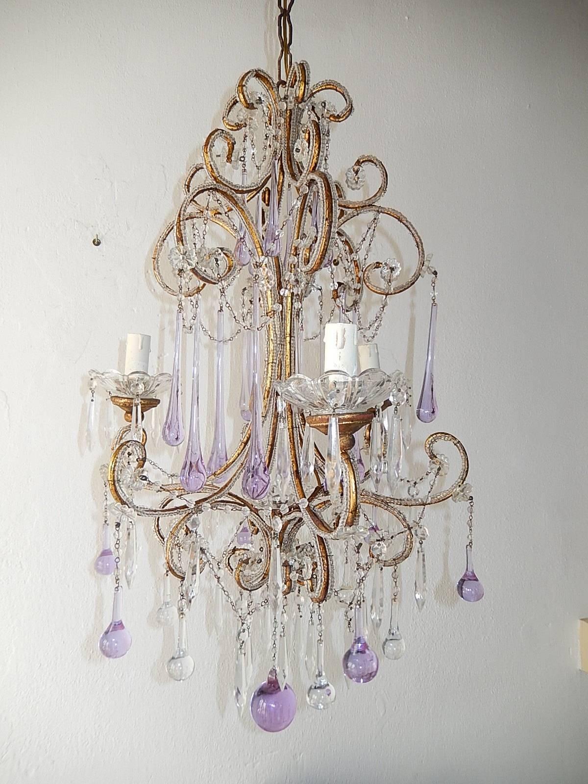 Housing three lights, sitting in crystal bobeches on top of giltwood posts. Also one in center. Beaded throughout with rare lavender Murano drops in all sizes. Rewired and ready to hang. Adding another 10.5 inches of original chain and canopy. Free