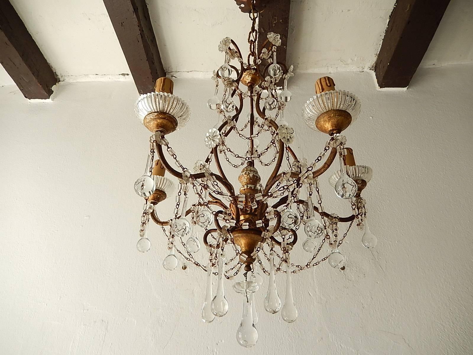 Rewired and ready to hang. Housing five lights, sitting in crystal bobeches. Giltwood on top, centre and bottom with florets and macaroni beading swags. Also adorning clear Murano drops. Adding another 9 inches of original chain and canopy. The wood