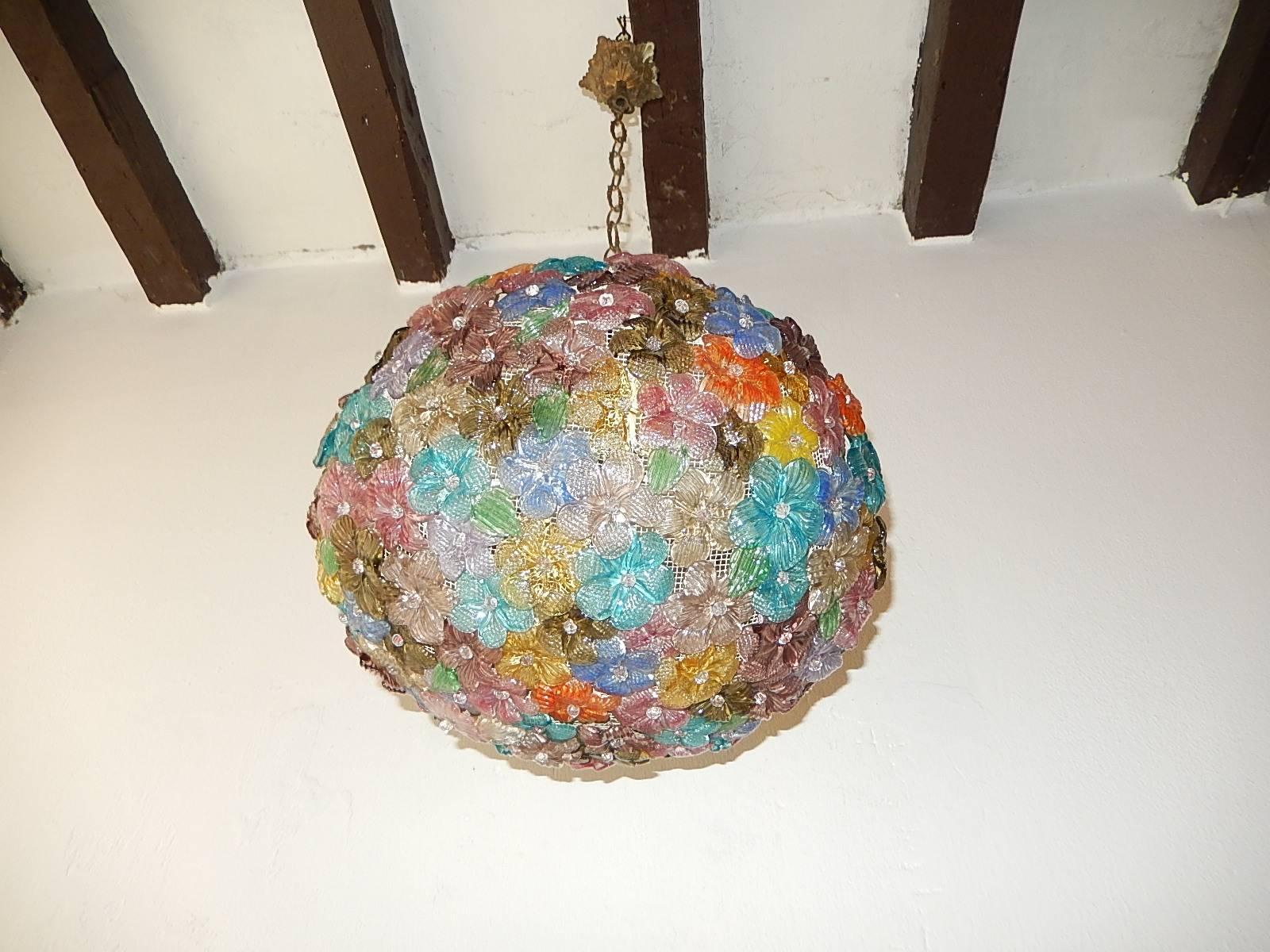 Housing three lights, will be rewired and ready to hang. Ball of Murano flowers in all shapes, sizes and colors with glass pins. Free priority shipping from Italy. Adding another 20 inches of original chain and canopy.