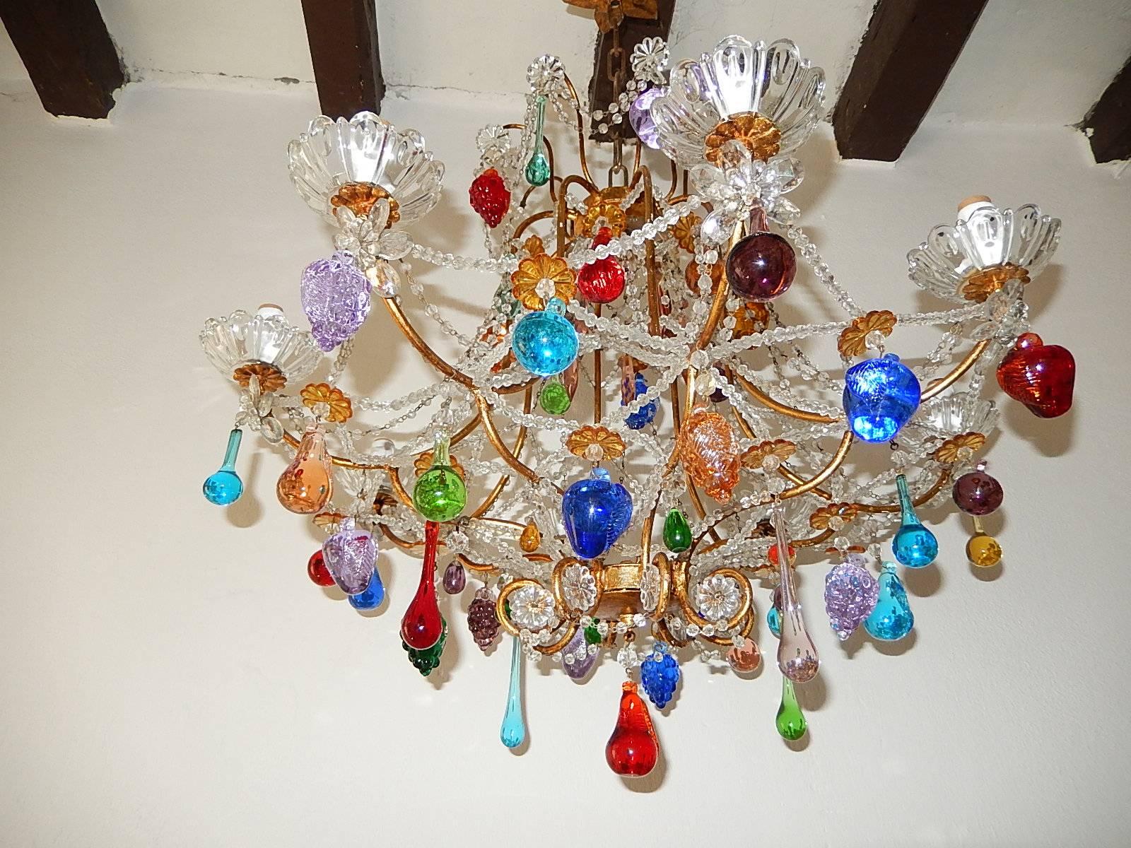 Housing eight-lights, rewired and ready to hang. All lights sitting in crystal bobeches. Beaded swags throughout. Adorning prism flowers, Murano fruit and drops in all shapes and colors. Adding 10 inches of original chain and canopy. Free priority