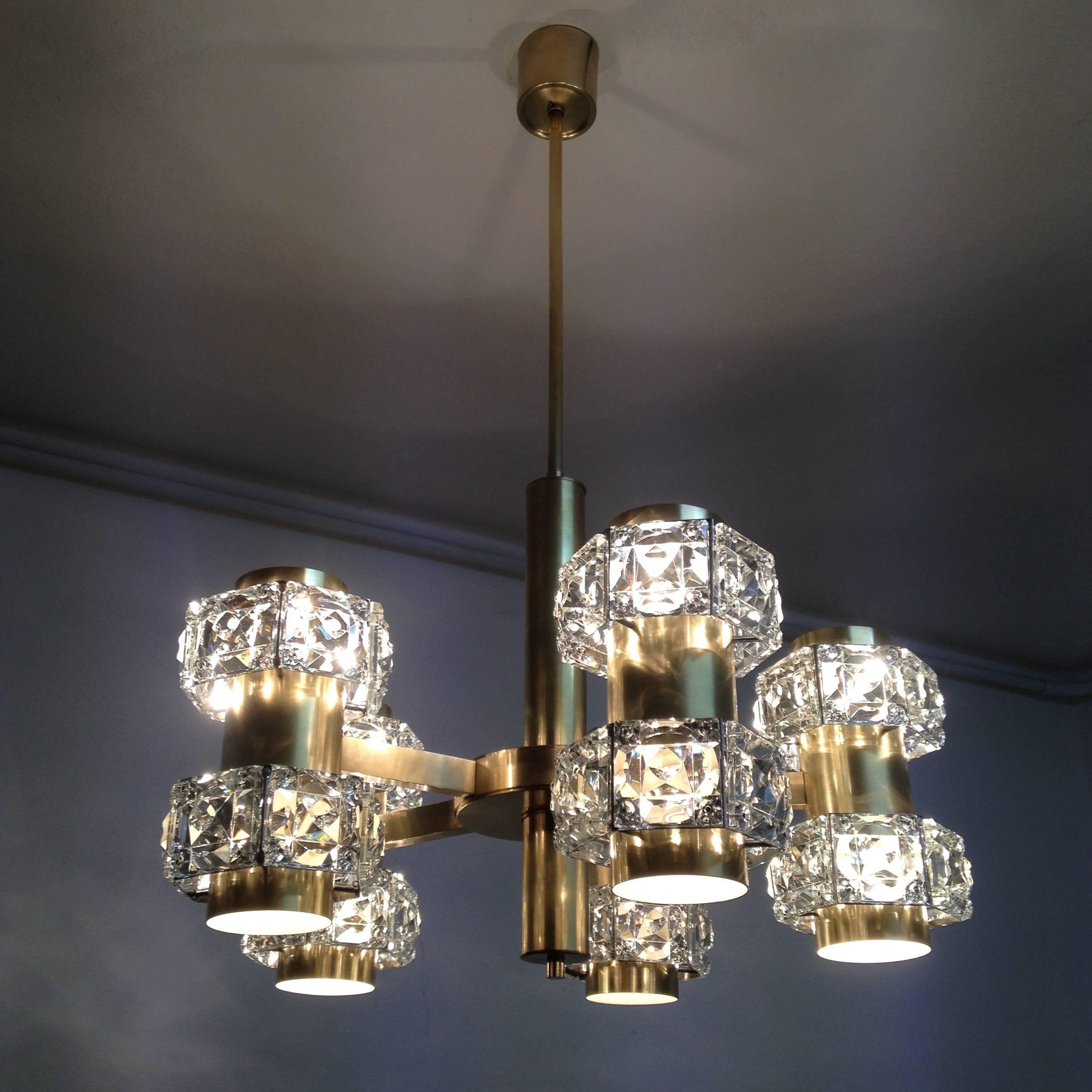 This is a rare and quite spectacular chandelier with five arms and double light fittings creating an up and down light effect which is being spread beautifully by the crystals that embrace the sconces that are set on the end of each arm. The brass
