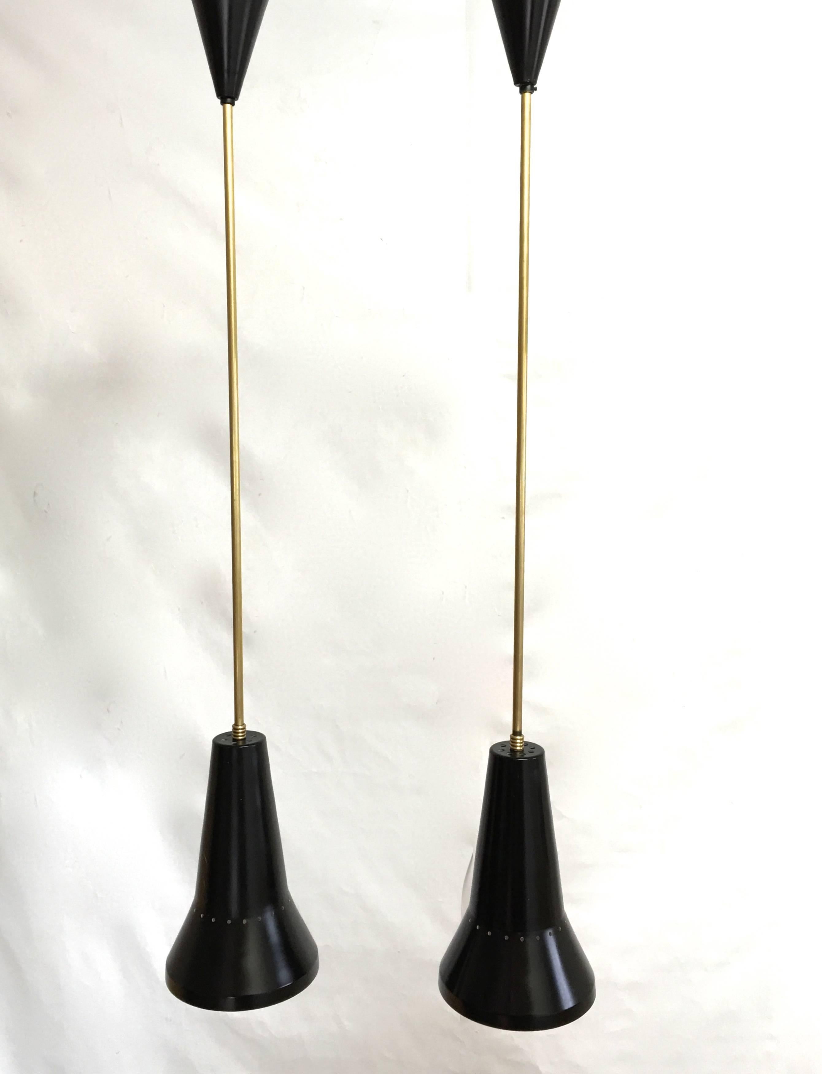 Two long stemmed pendants with black sconce and black ceiling rose in midcentury Minimalist design.
                 