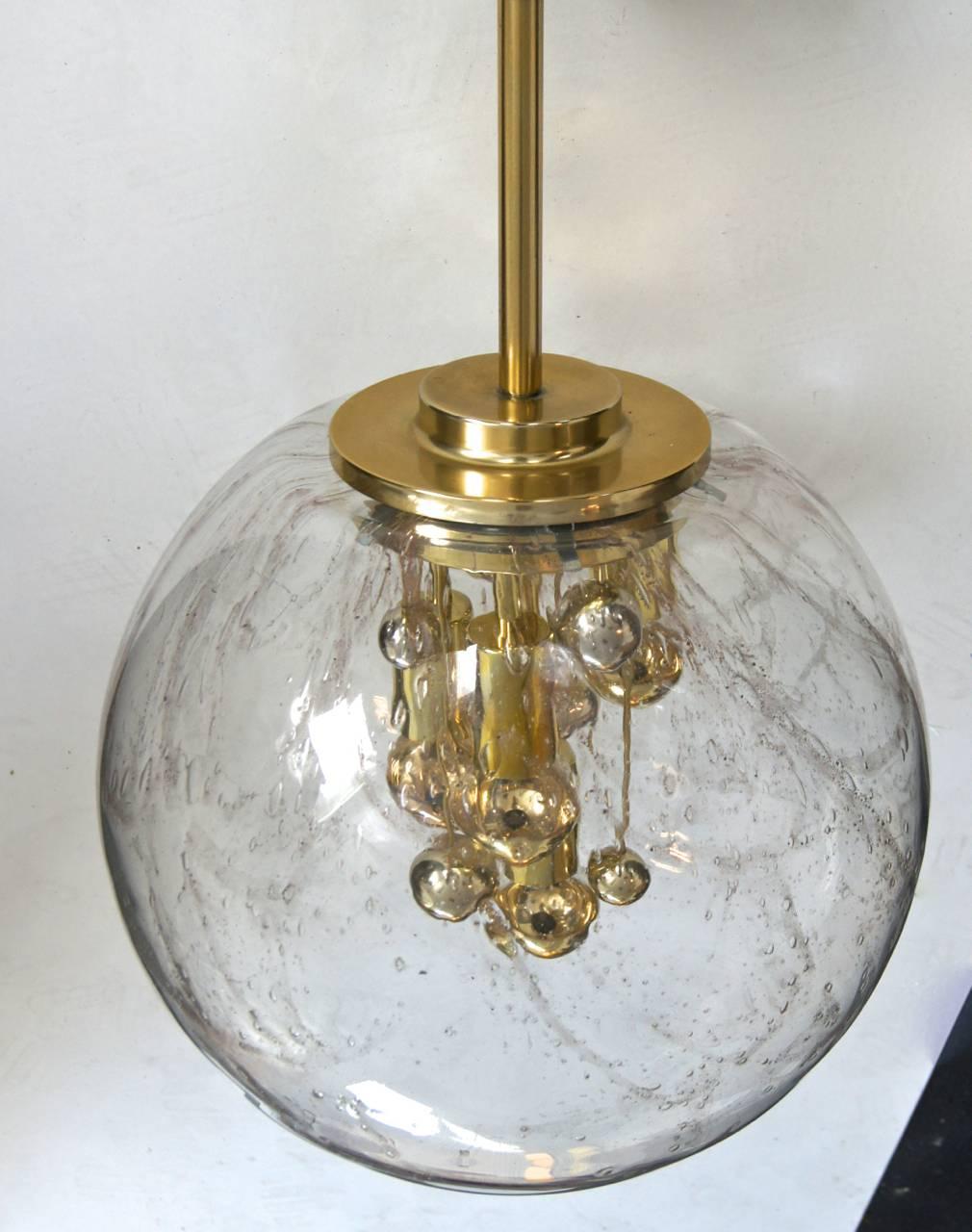Large handblown textured globe with gold swirl. Manufactured by Doria in the 1970s. Brass interior fittings set in different lengths complimented with gold tipped bulbs.