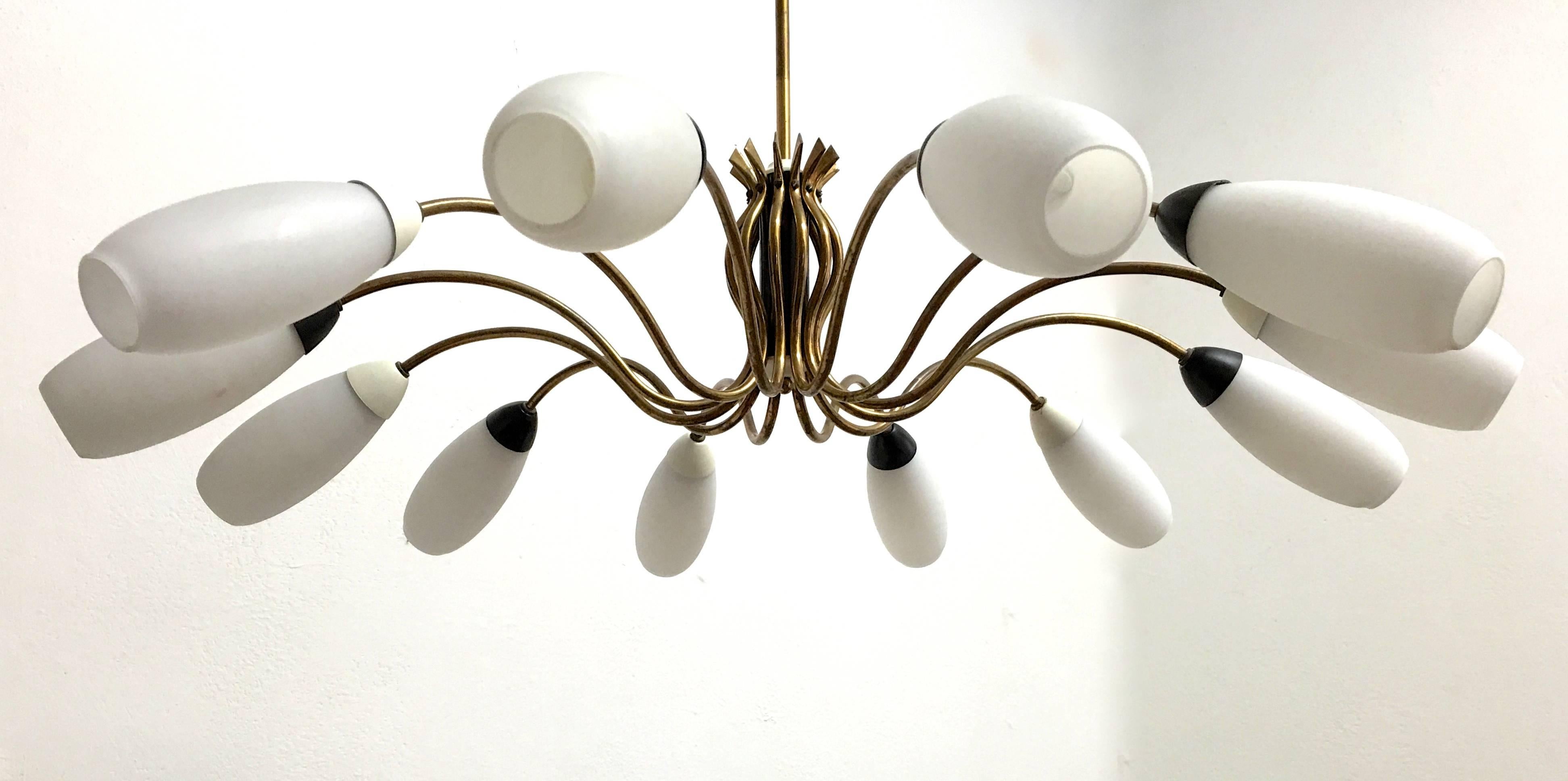Twelve-arm Italian chandelier with opaline glass shades and black and white light fittings. Brass structure. The height can be suspended.