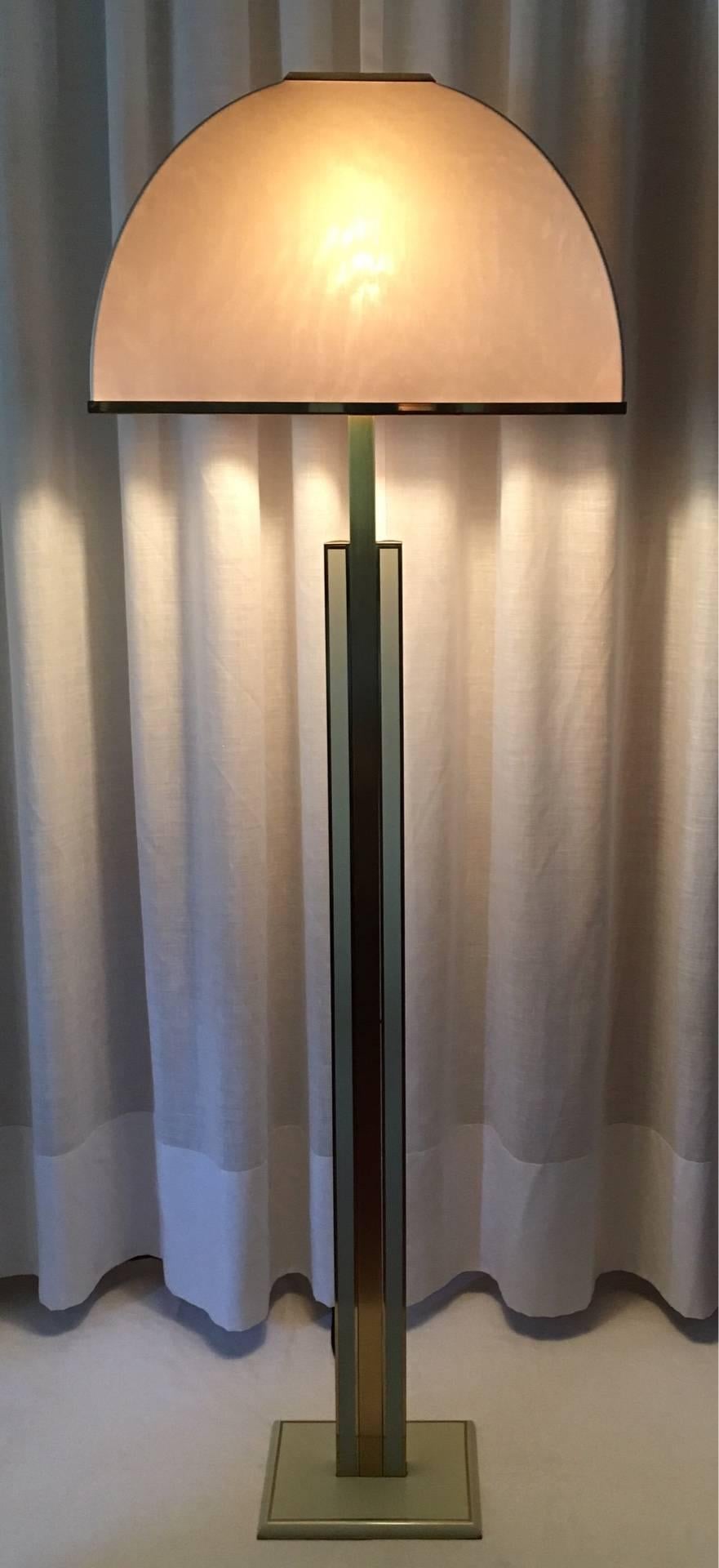 Italian floor lamp with an enameled metal and brass base and its original shade in stretched fabric with brass details.
Requires one standard bulb.