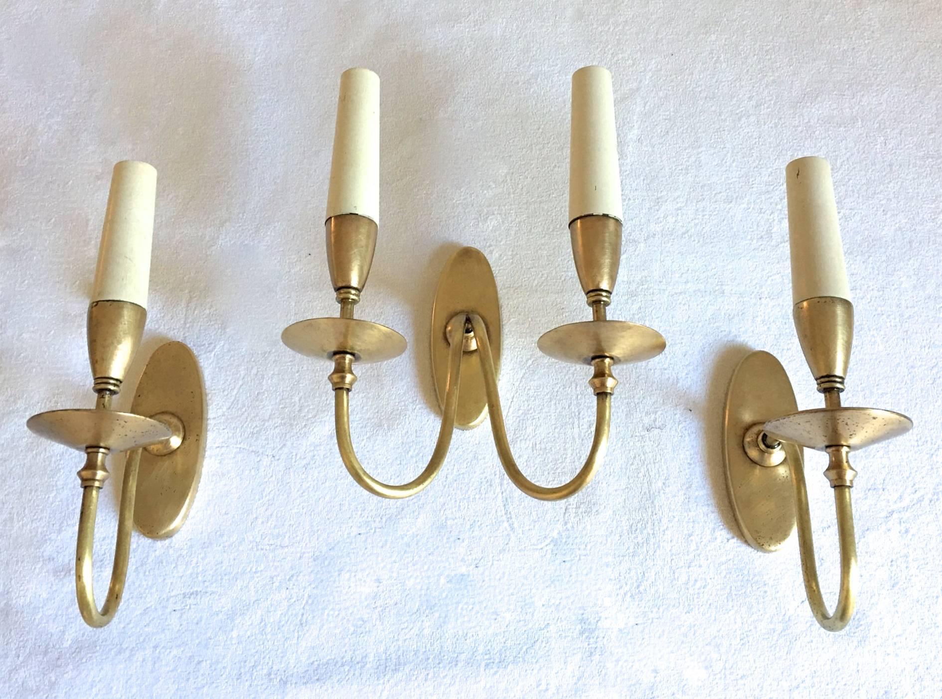 A set of three wall sconces, two singular and one double designed in the 1940s, Italy.
labelled on the back.