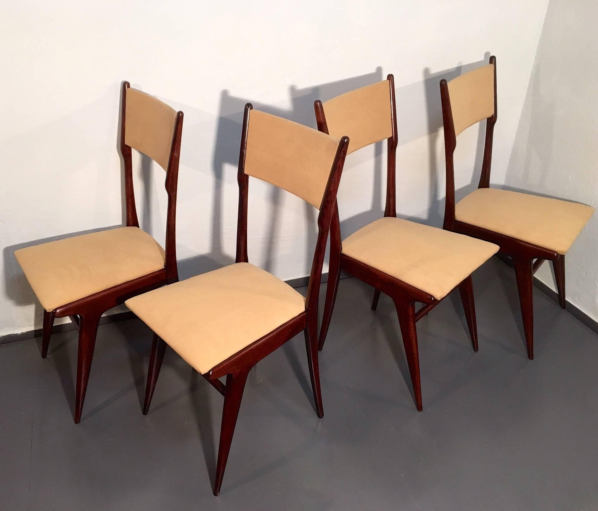 Wonderful set of Italian Mid-Century dining chairs upholstered in camel colored alcantara. Very subtitle features and elegant lining. Dark colored beech frame.