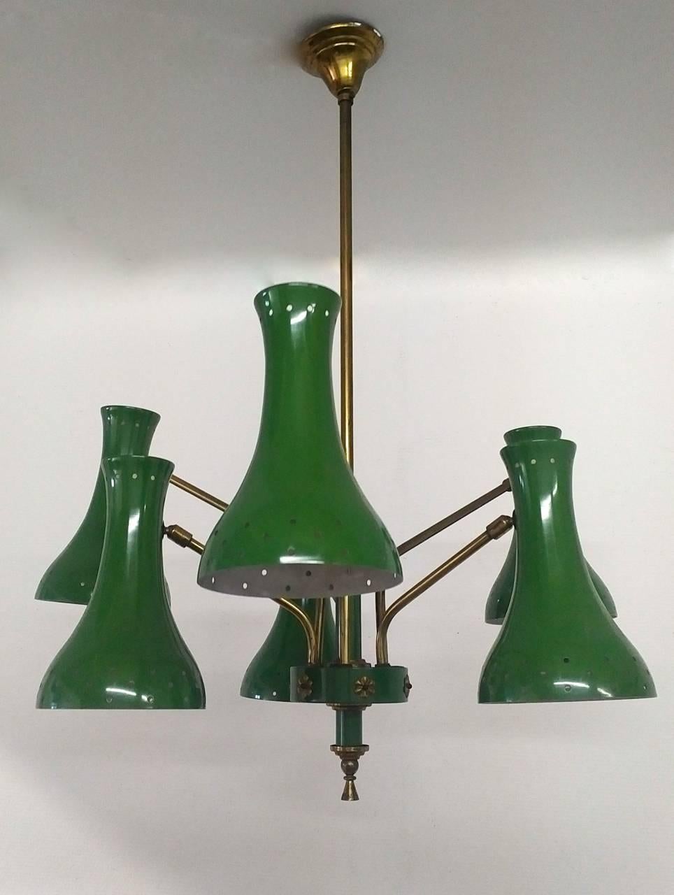 A six-arm chandelier in typical Italian Mid-Century green with diabolo shaped diffusers and circle perforated rims that spread the light across the room. Brass suspension and details. The arms that have two lengths create a double tier effect and
