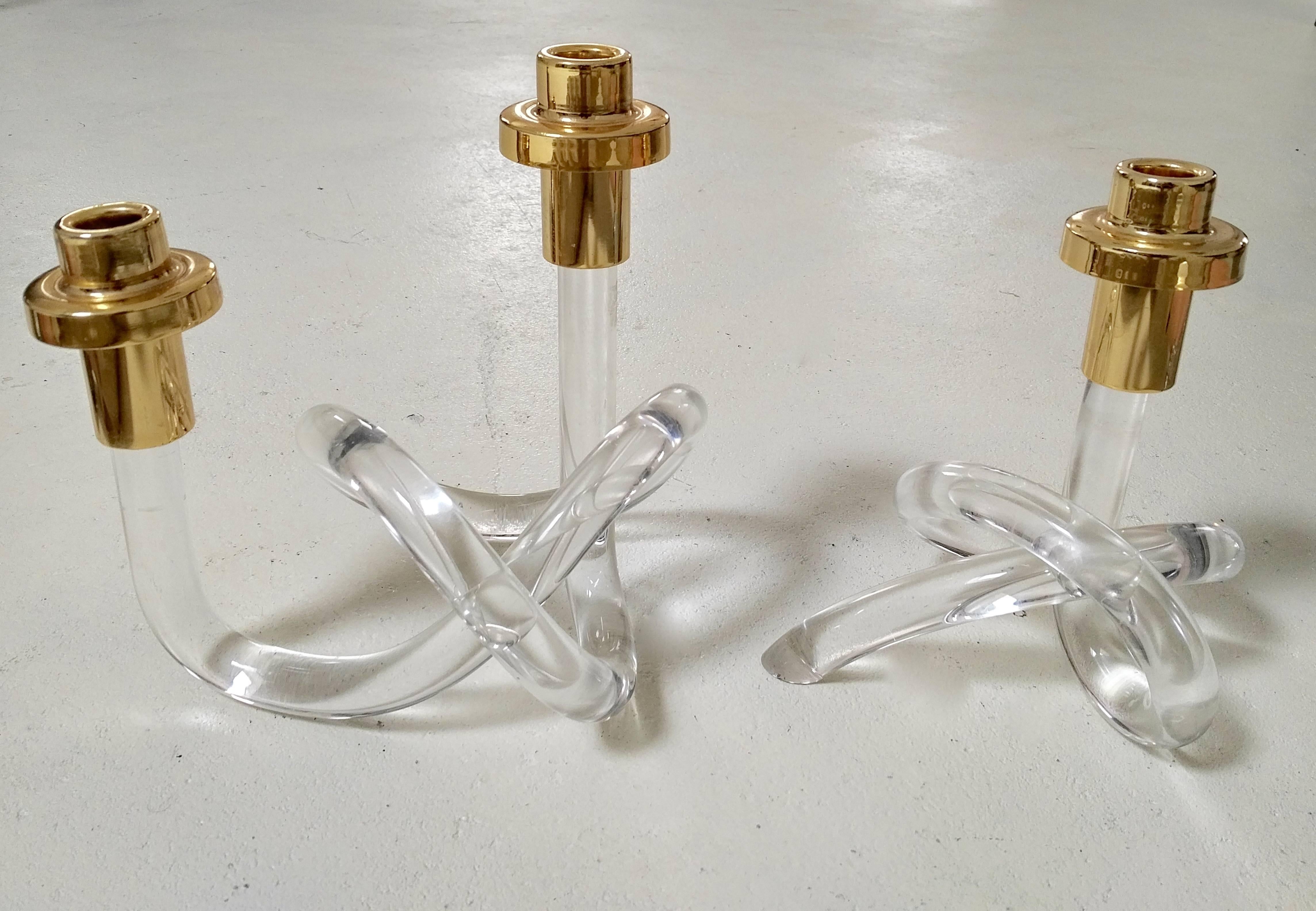 Beautiful pair of twisted Lucite and gold candleholders. These 'pretzel' shaped candleholders are a modernist icon. Dorothy Thorpe was a Pioneer in using this transparent acrylic material, experimenting with it since the early 1940s. This is truly
