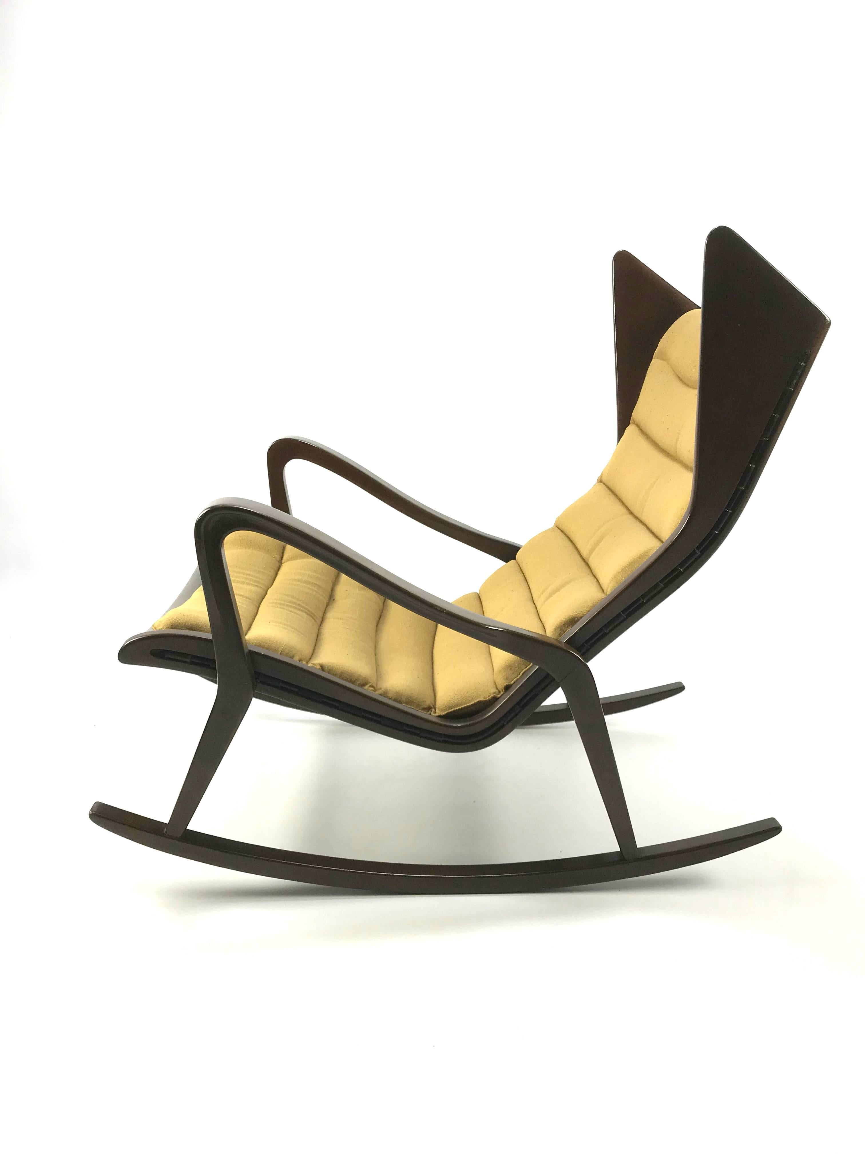 Rare rocking chair model 572 produced by Cassina, circa 1955. Conceived in walnut, fabric upholstering and rubber. 
According to Salvatore Licitra at the Gio Ponti Archives, Milan, this chair is likely to have been designed by Gio Ponti.
Beautiful