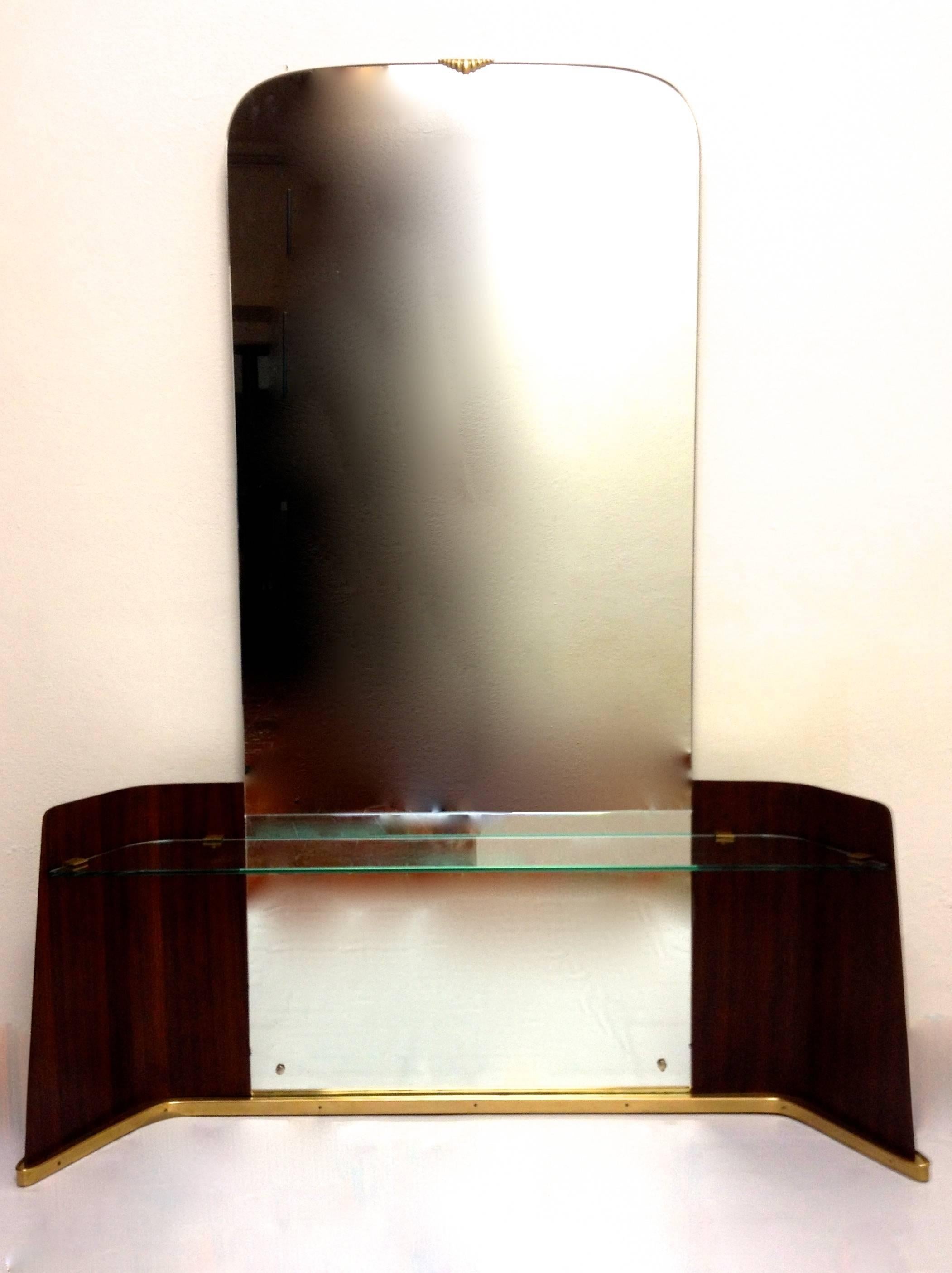 A mirror with glass console, high quality manufactured by Italian company Saffa who executed furniture for a number of iconic designers such as Gio Ponti and Guglielmo Ulrich. This mirror is attributed to Ulrich. It carries the manufacturers stamp