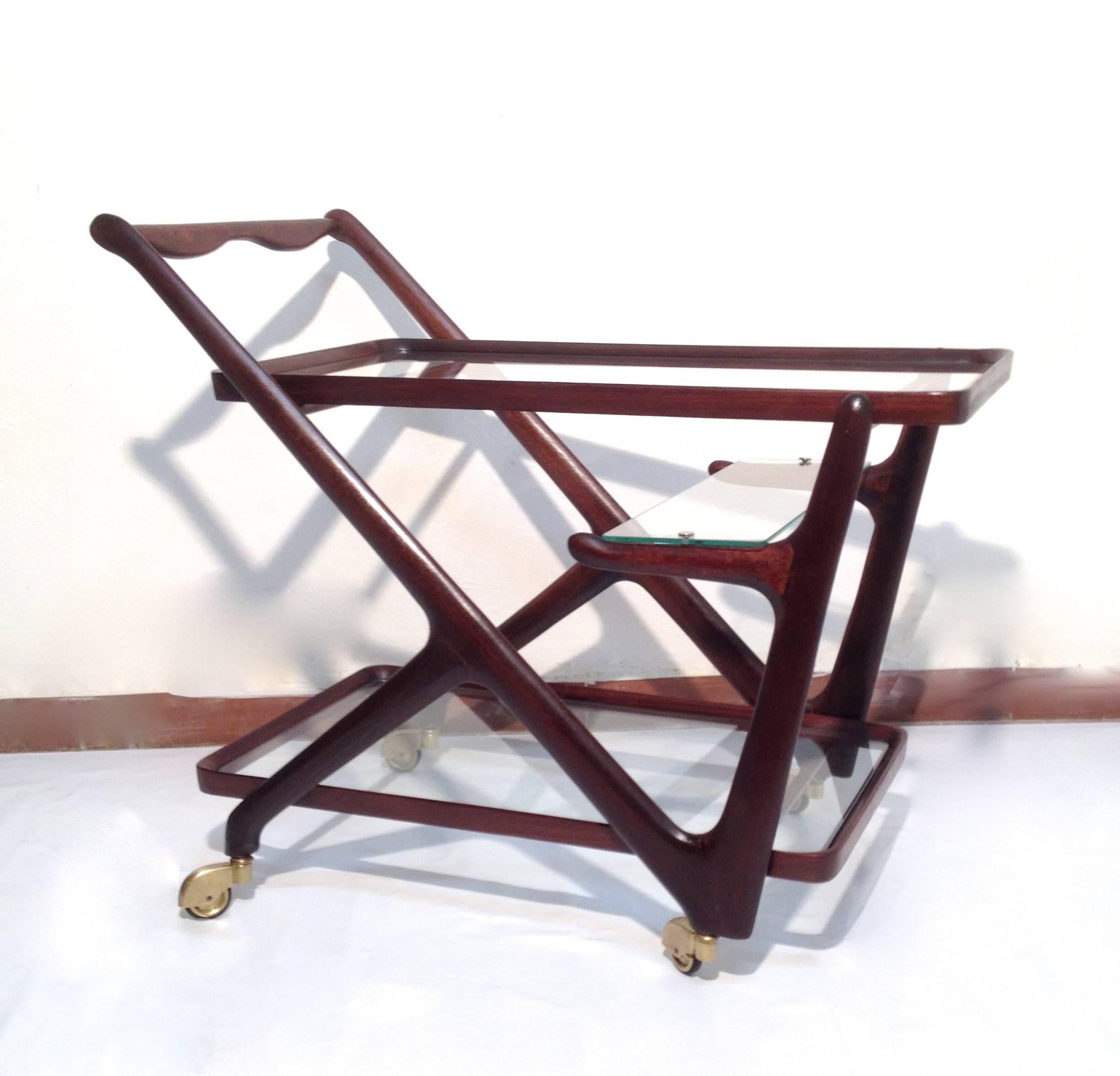 Original and wonderful condition bar cart / trolley from Italian designer Cesare Lacca for Cassina. 
Mahogany with original glass and brass wheels.