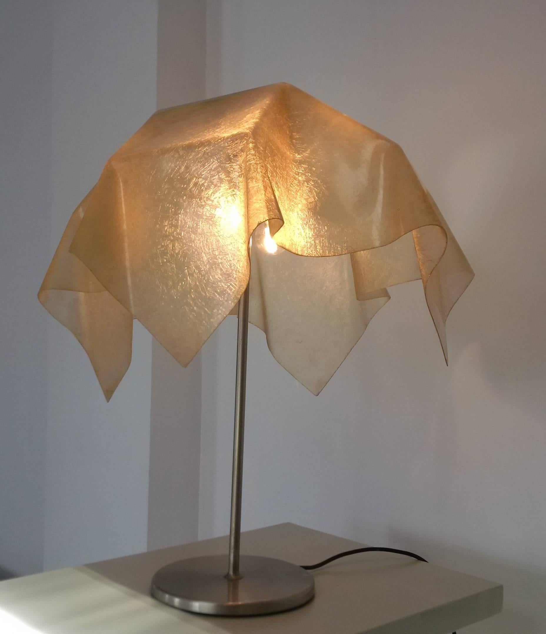 A rare table lamp by Valenti. A fiberglass cloth or tissue is draped over the foot of this lamp with dramatic effect. Different from every angle.